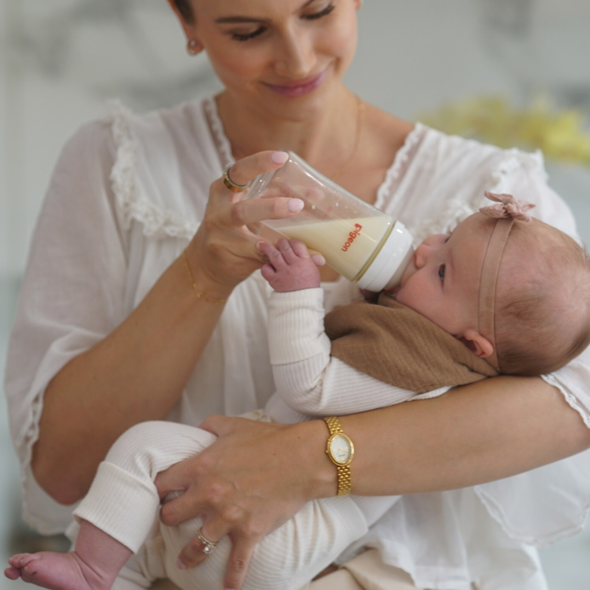 pigeon glass baby bottle being fed to baby