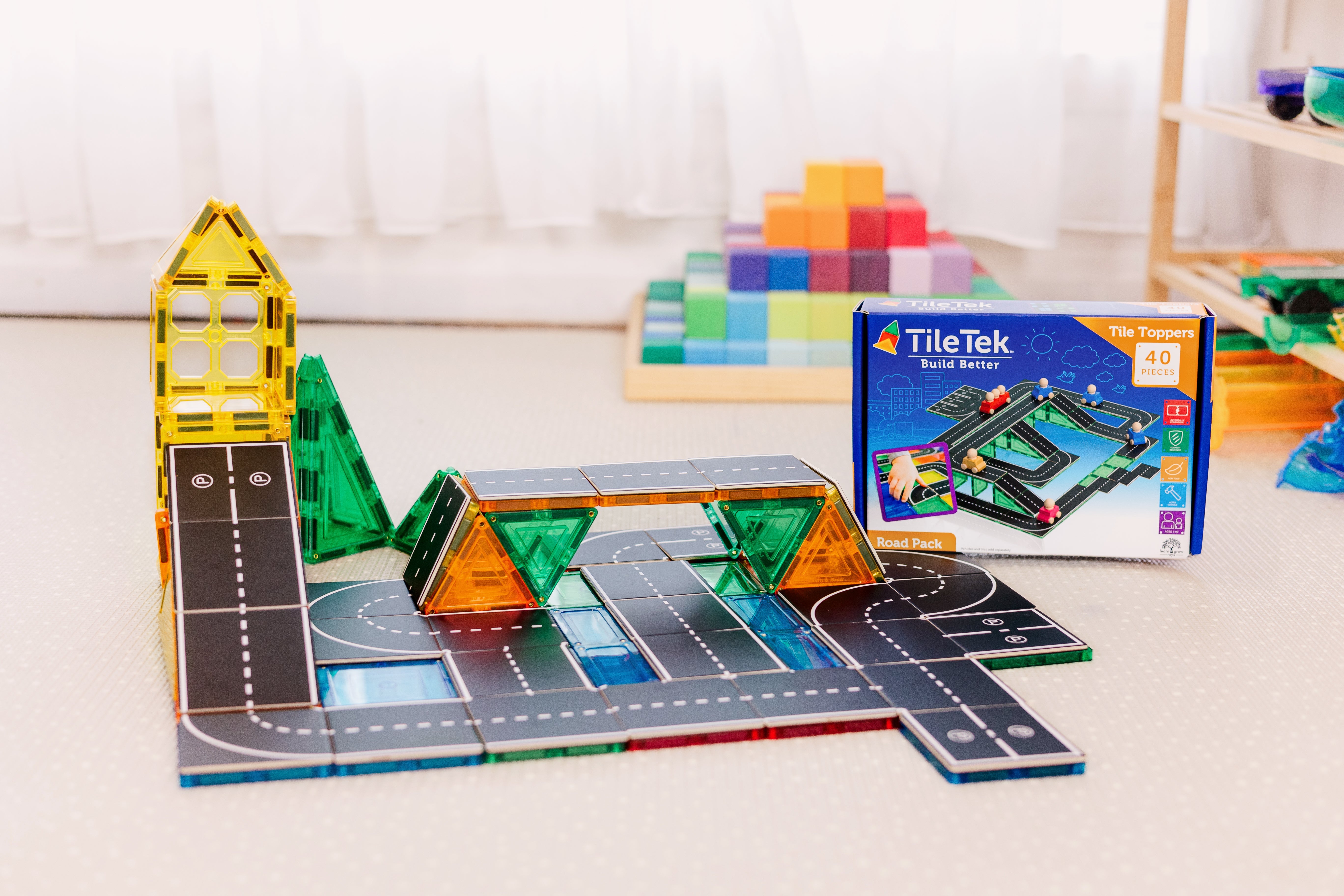 Child building a road network with the Road Pack tile toppers