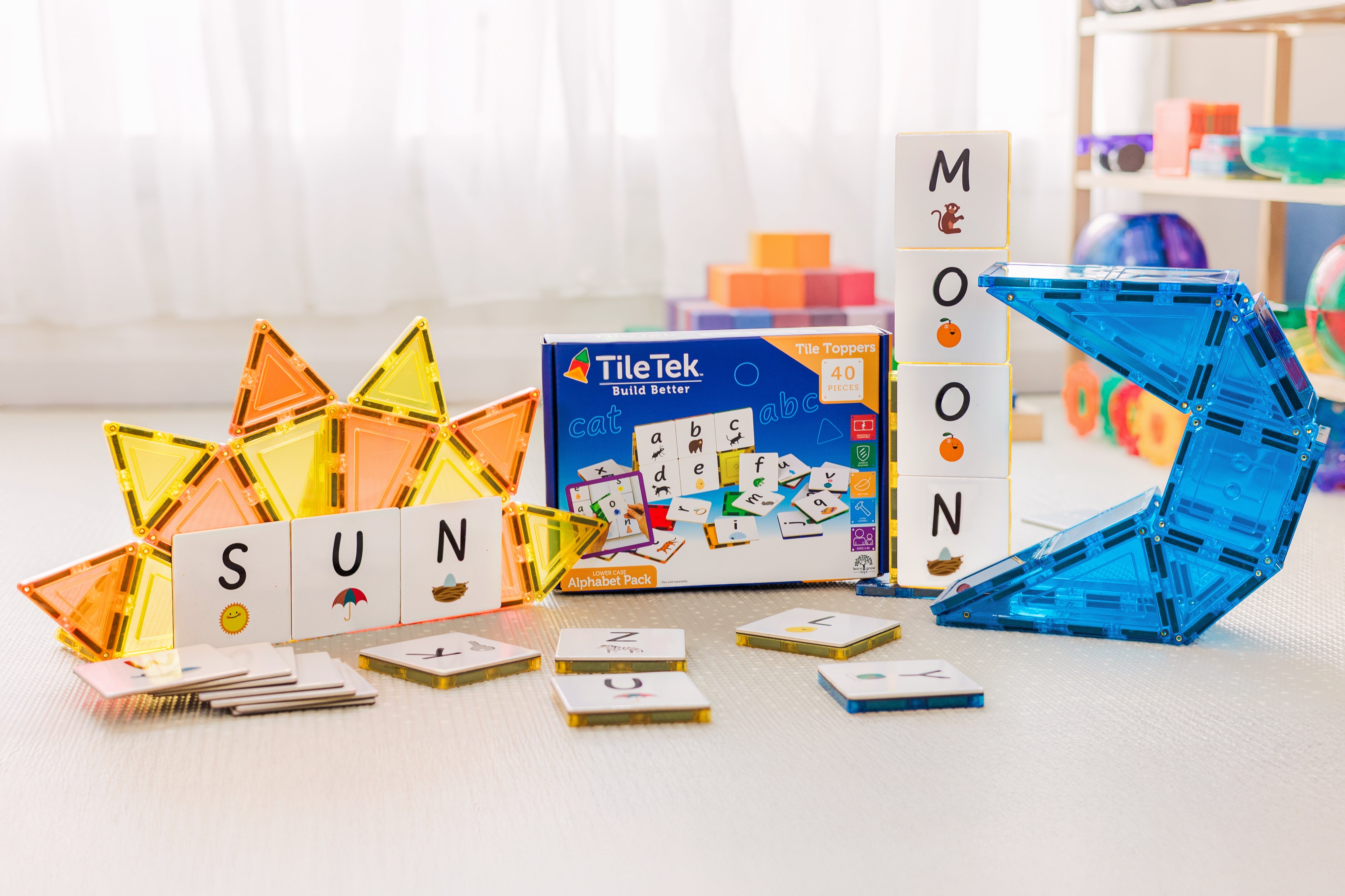 Child spelling words with the Alphabet Upper Case Pack toppers