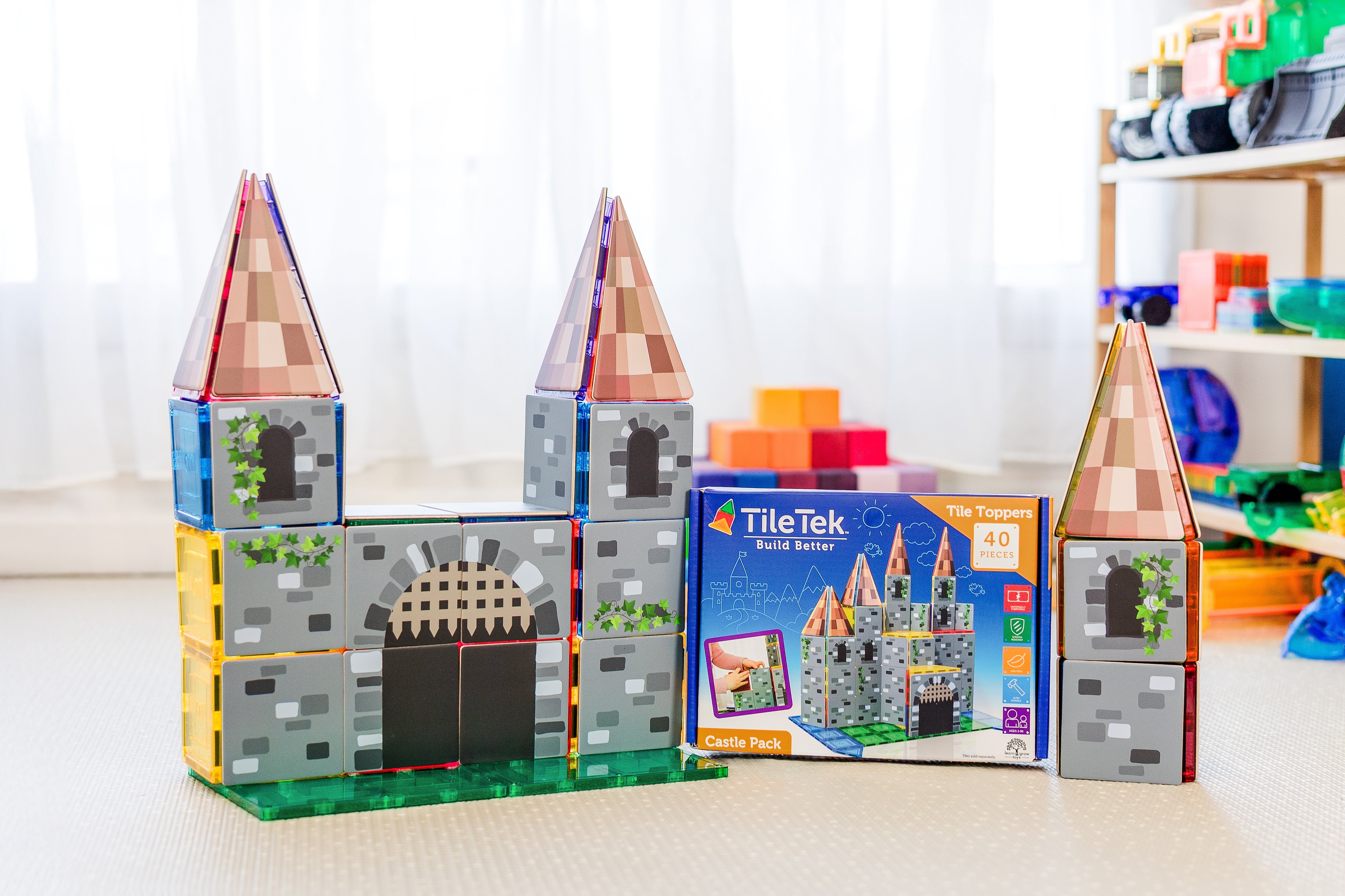 Child building a castle with the Castle Pack tile toppers