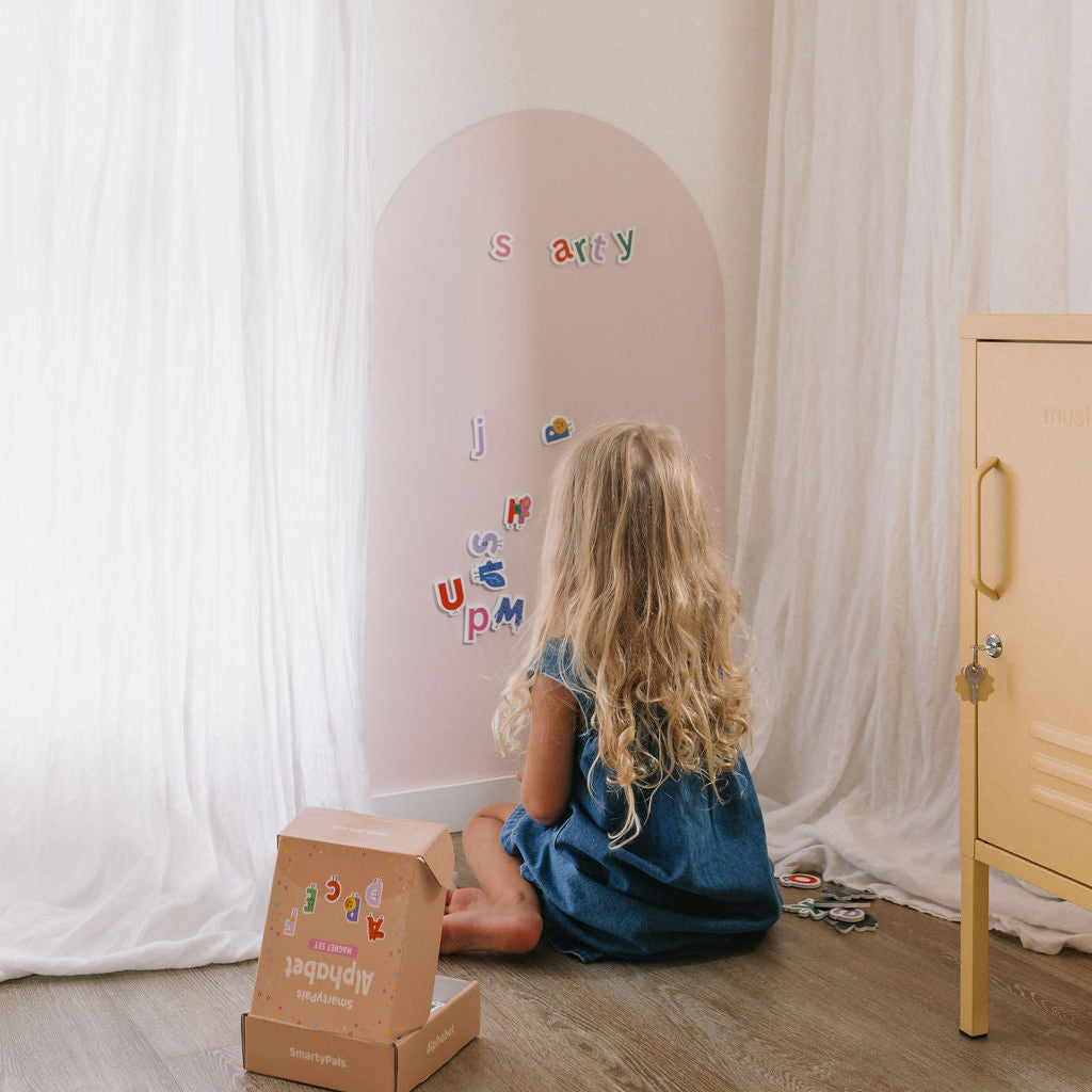 Smartypals alphabet magnets on a play wall