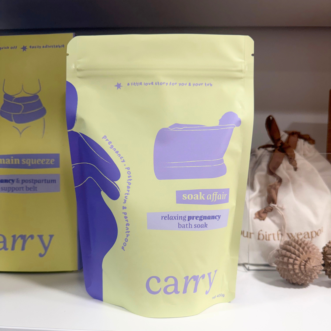 Carry Soak Affair pregnancy bath soak on a shelf with the Carry Main Squeeze support belt