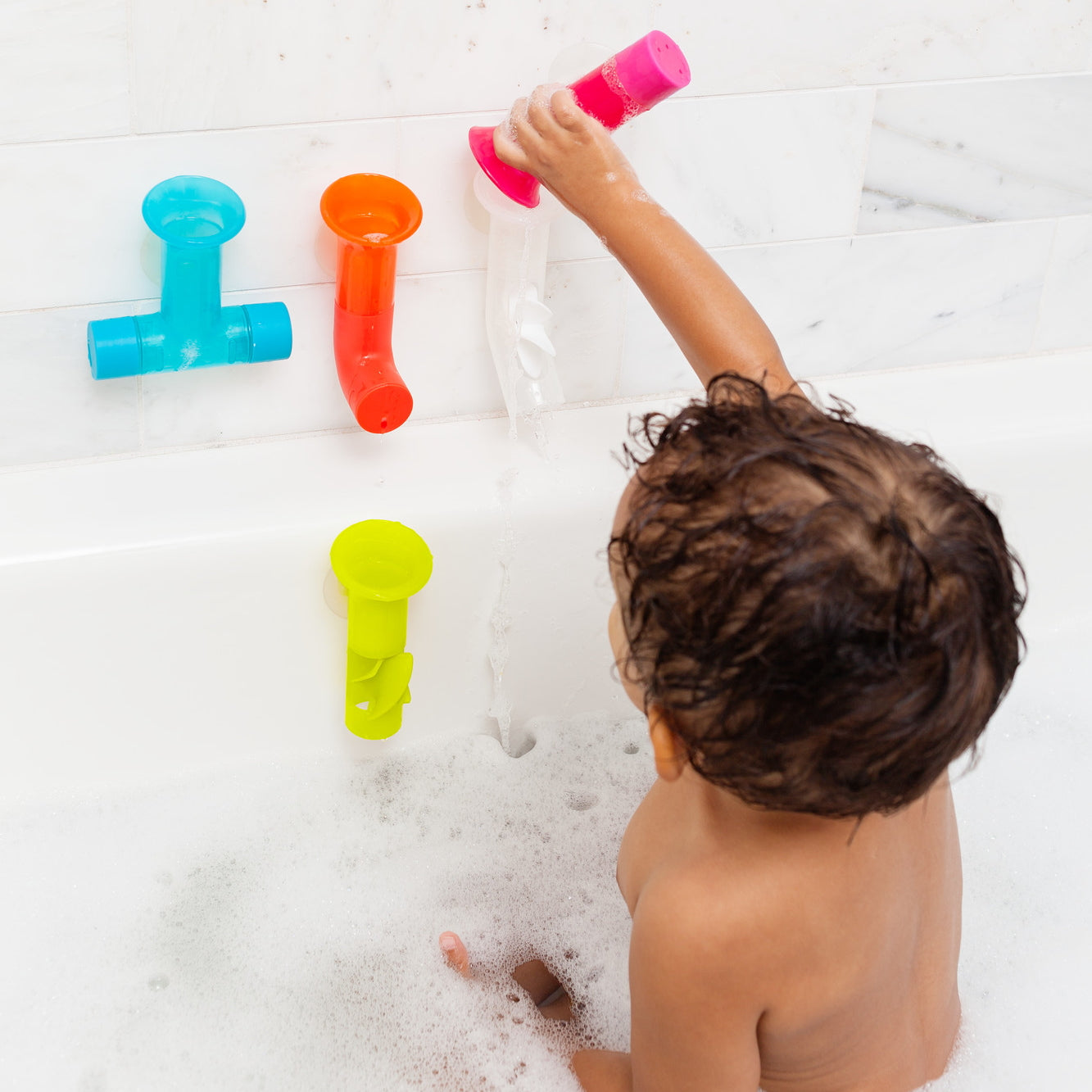 Boon Pipes Bright bath toys suctioned to the bath wall