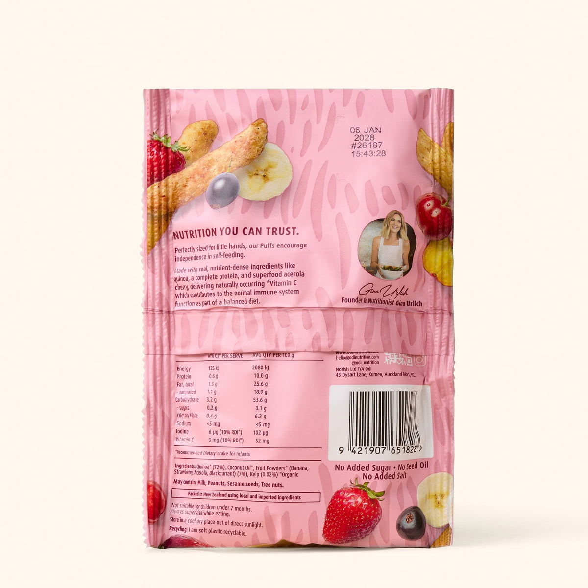 Baby picking up Odi Organic Berry and Banana Quinoa Puffs