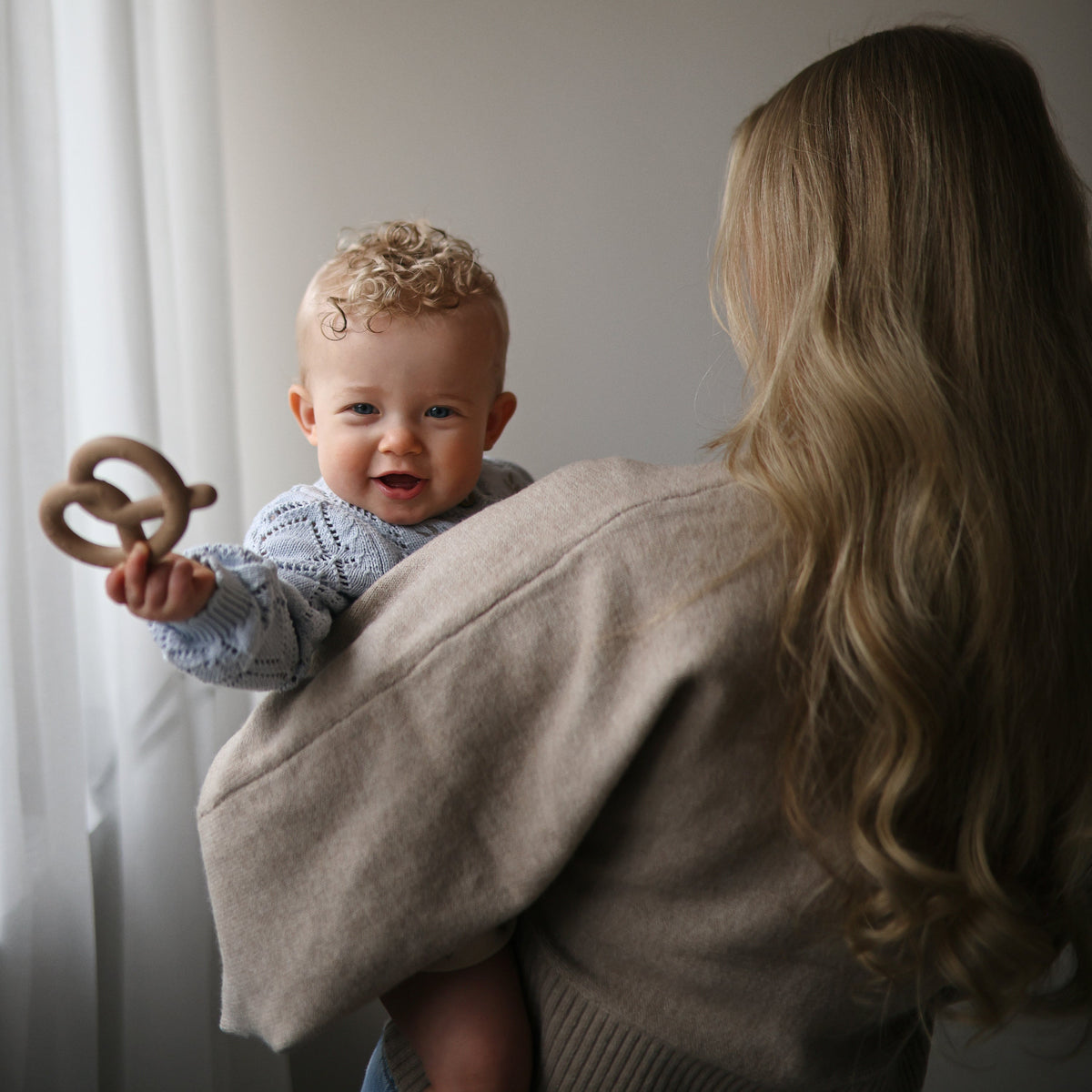 Baby with the Mushie Pretzel Teether