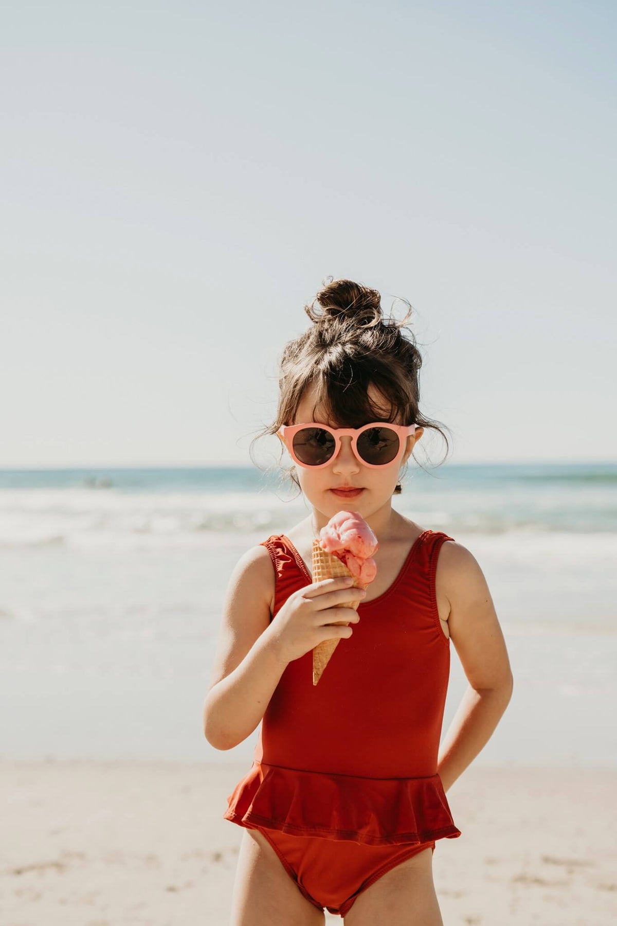 Child wearing Frankie Ray ECO Kids Sunglasses in Coral Pink