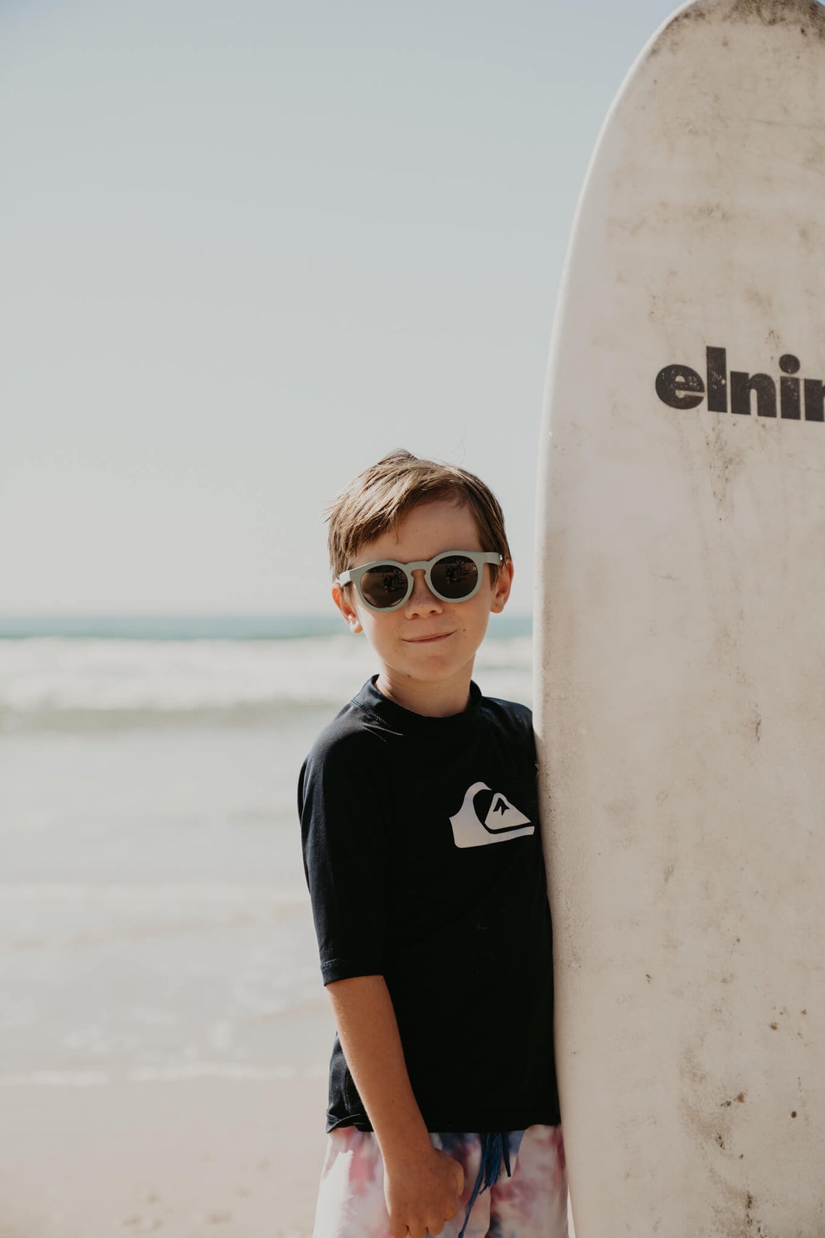 Child wearing Frankie Ray ECO Kids Sunglasses in Kelp Green