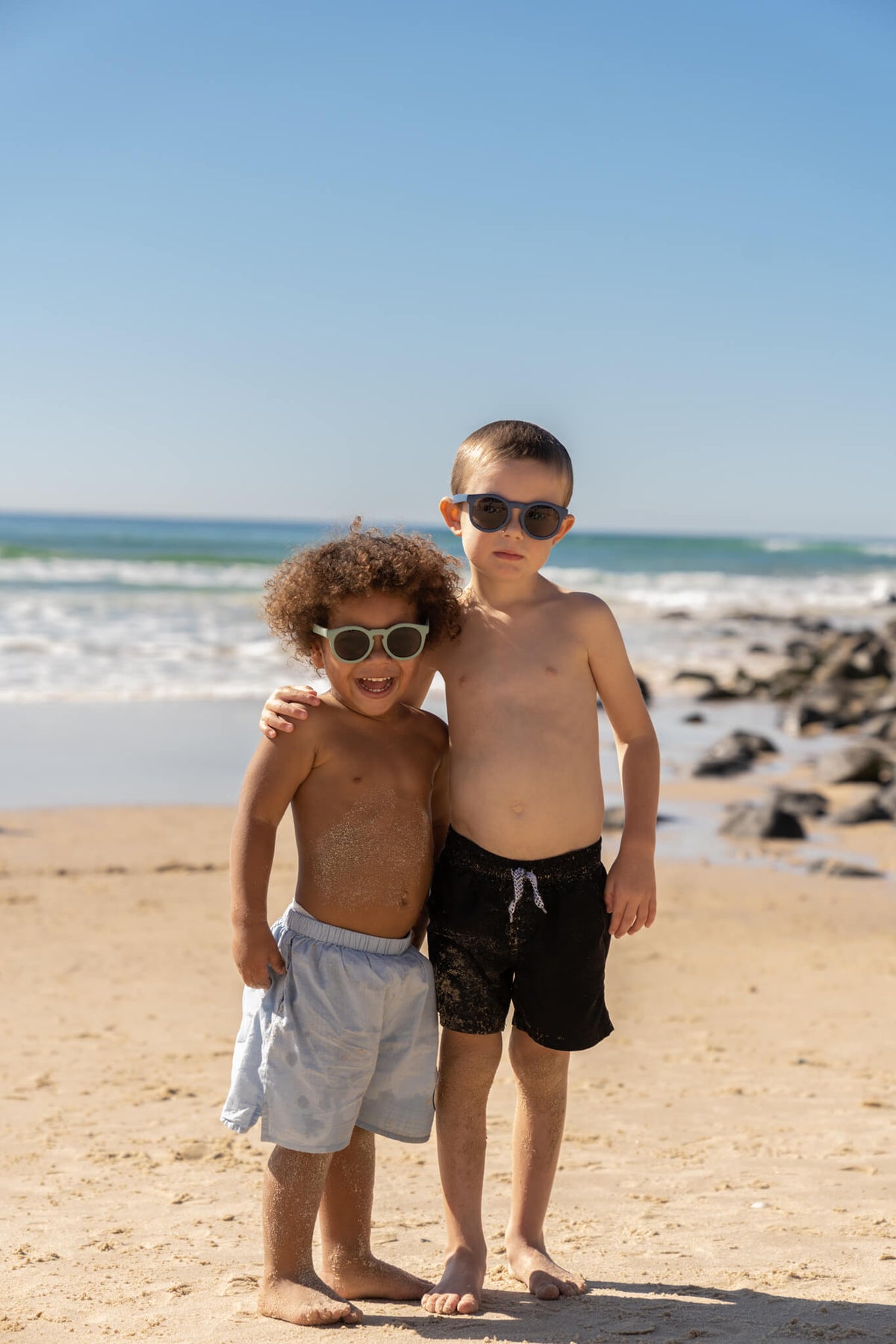 Kids wearing Frankie Ray ECO Kids Sunglasses in Kelp Green and Ocean Blue