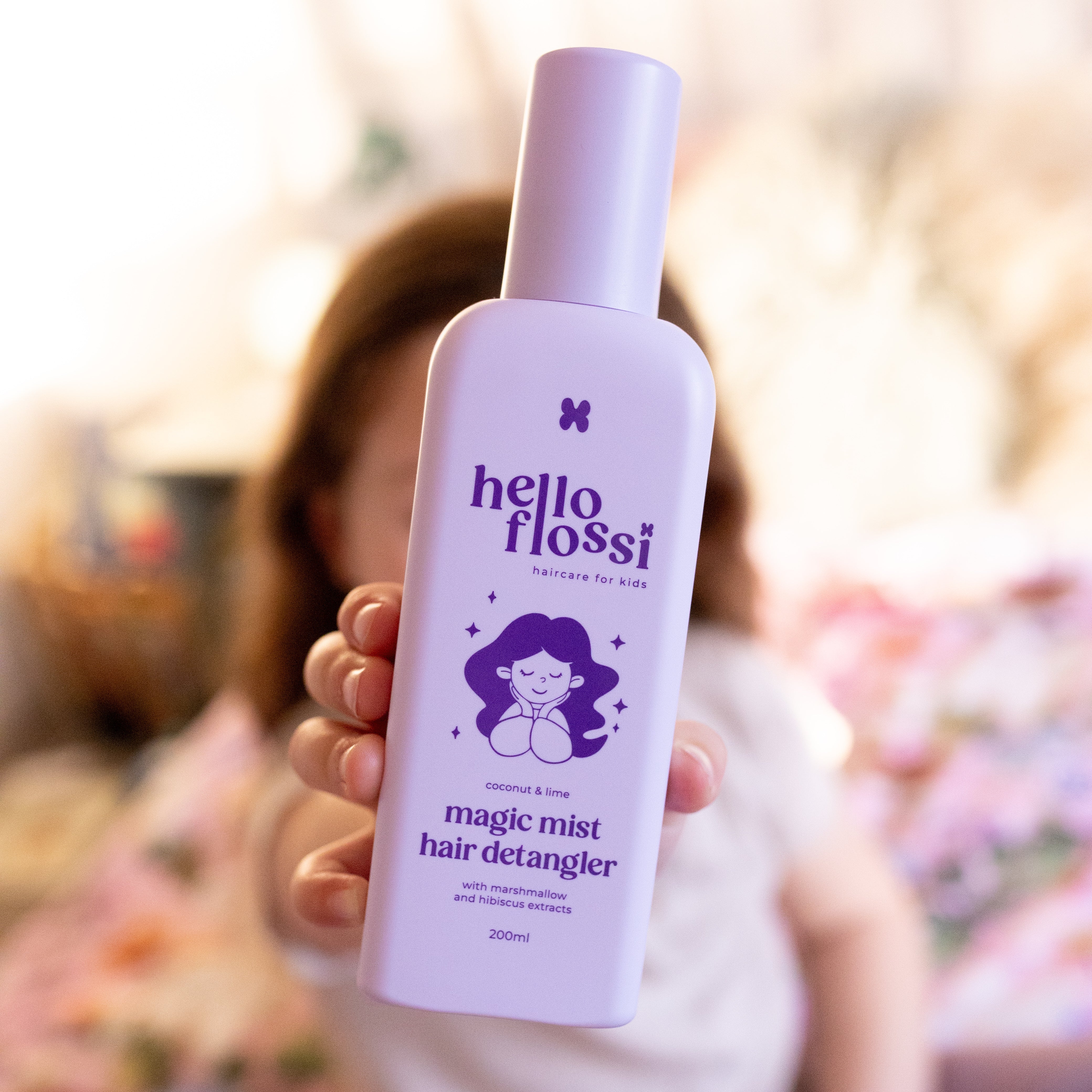 Magic Mist detangler spray being used on a child's hair