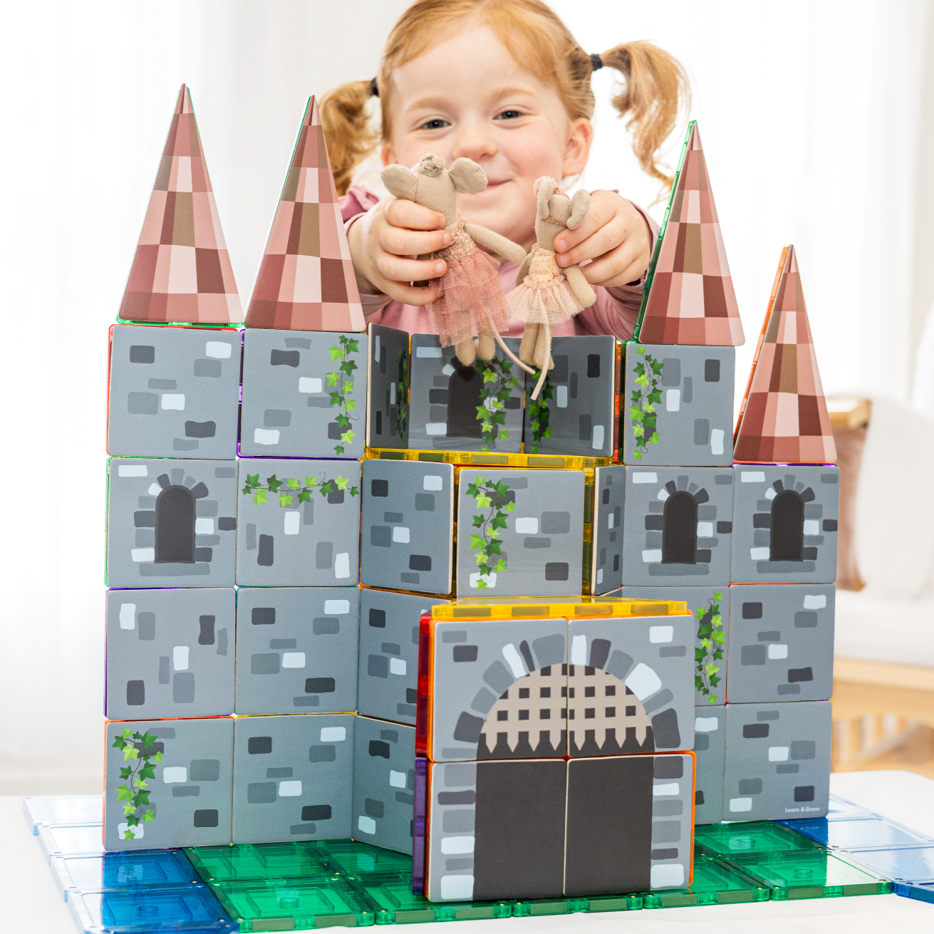 Castle Pack toppers built into a magnetic tile castle with toy figures