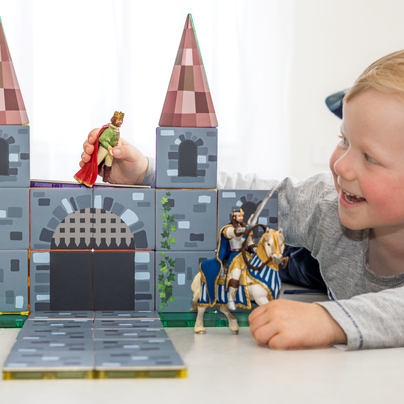Castle Pack toppers forming turrets on a magnetic tile castle