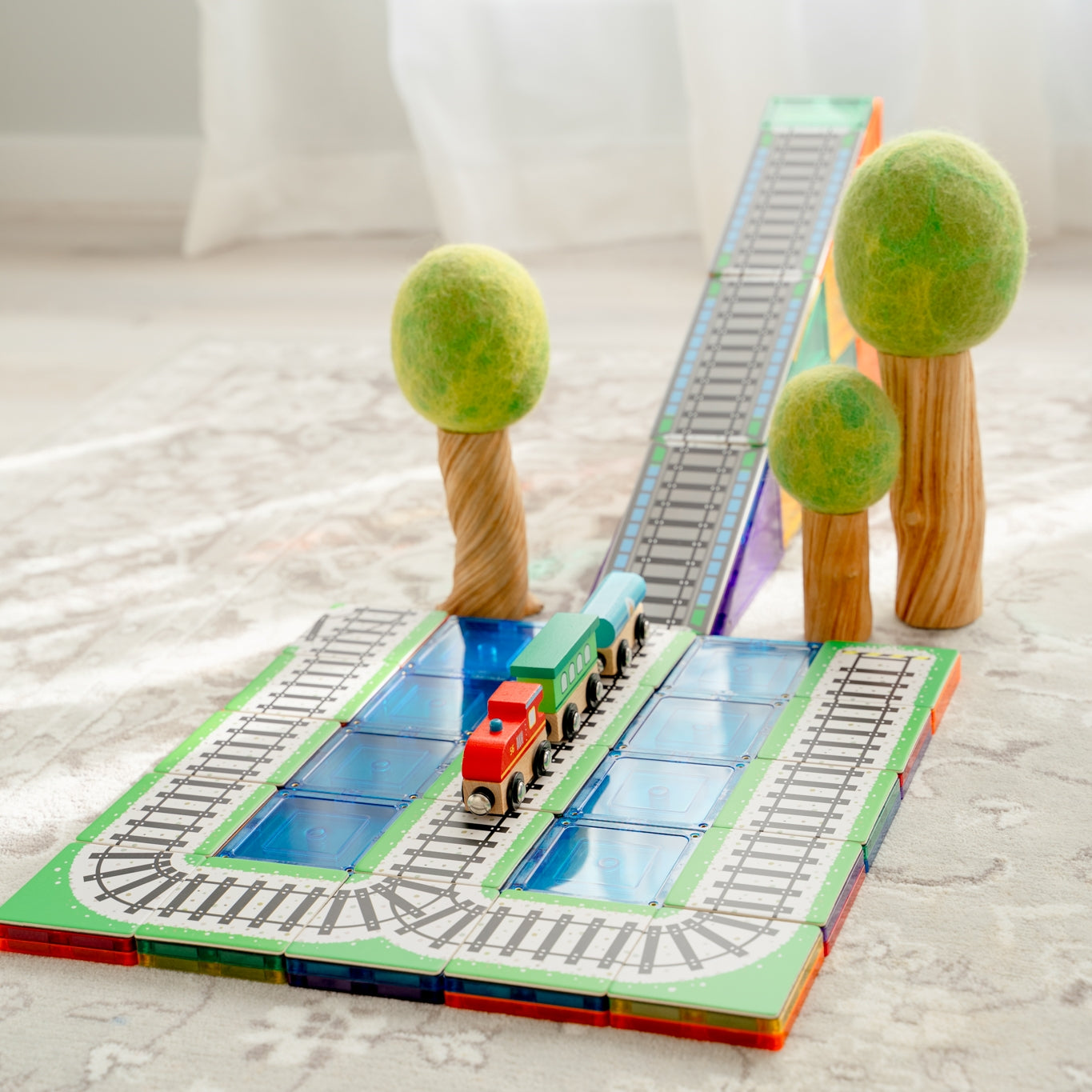 Train Pack toppers set up with wooden trees in a bright playroom