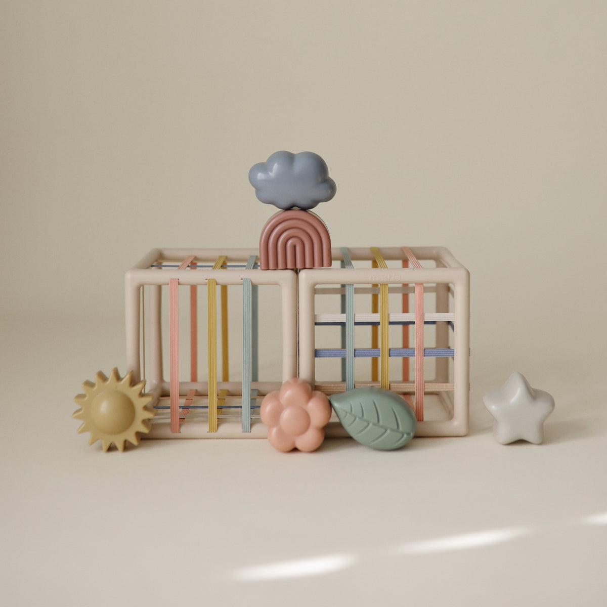 Mushie Elastic Shape Sorter in use