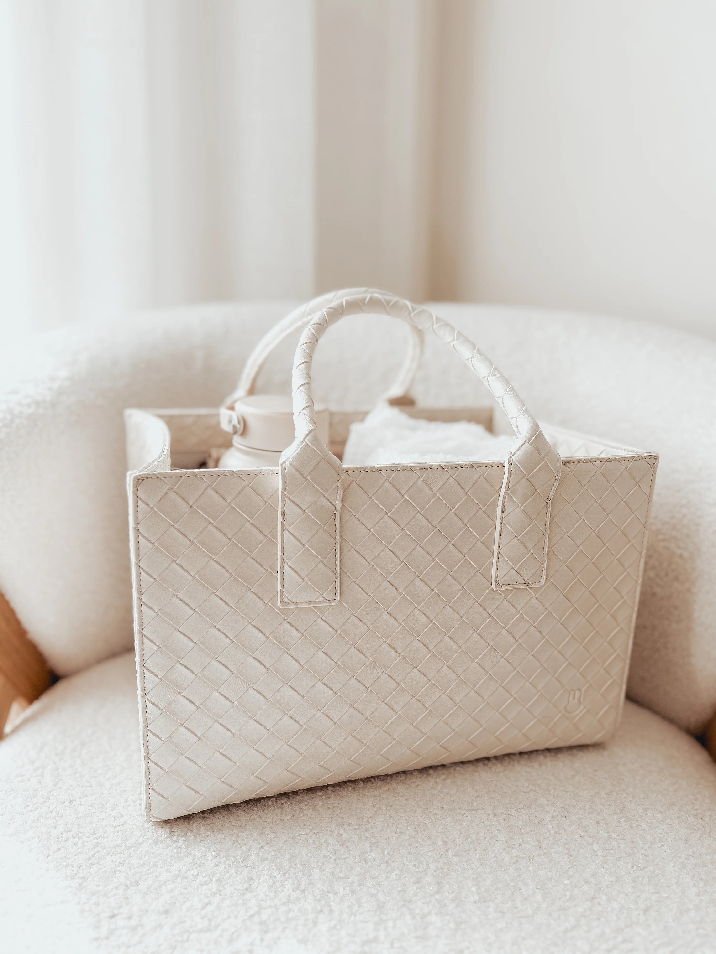 White quilted tote bag on a white couch