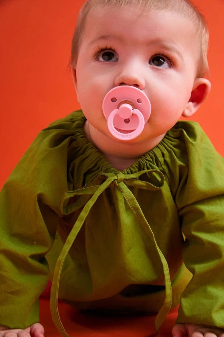bibs round colour glow pacifiers in baby pink and tango