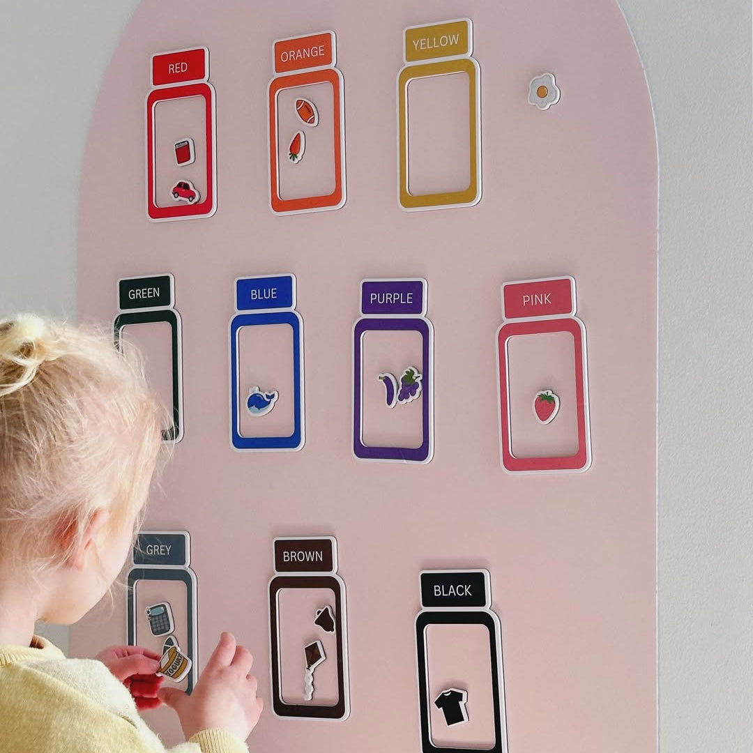 Child sorting colours with Smartypals magnetic jars