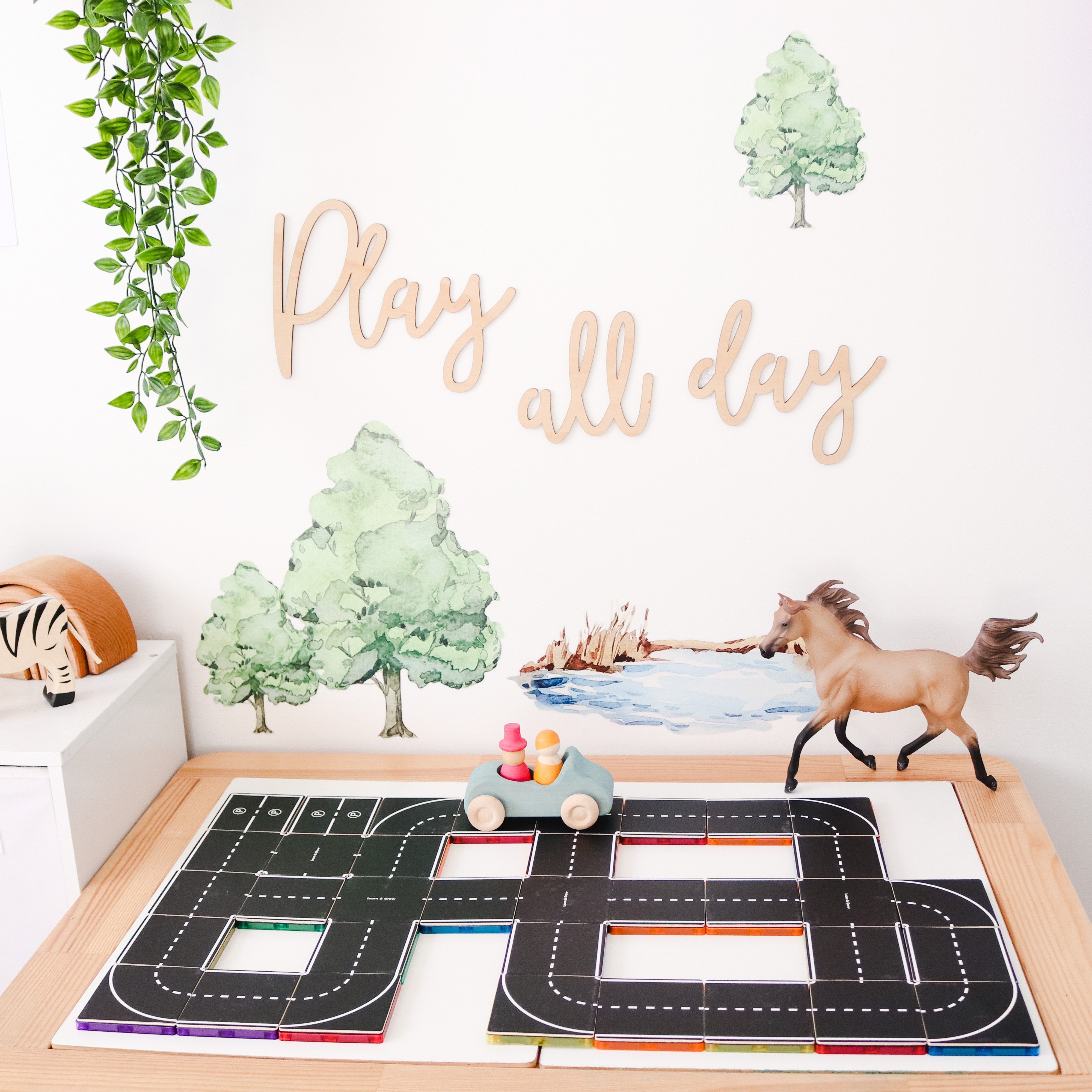 Child playing with the Road Pack tile toppers and toy cars