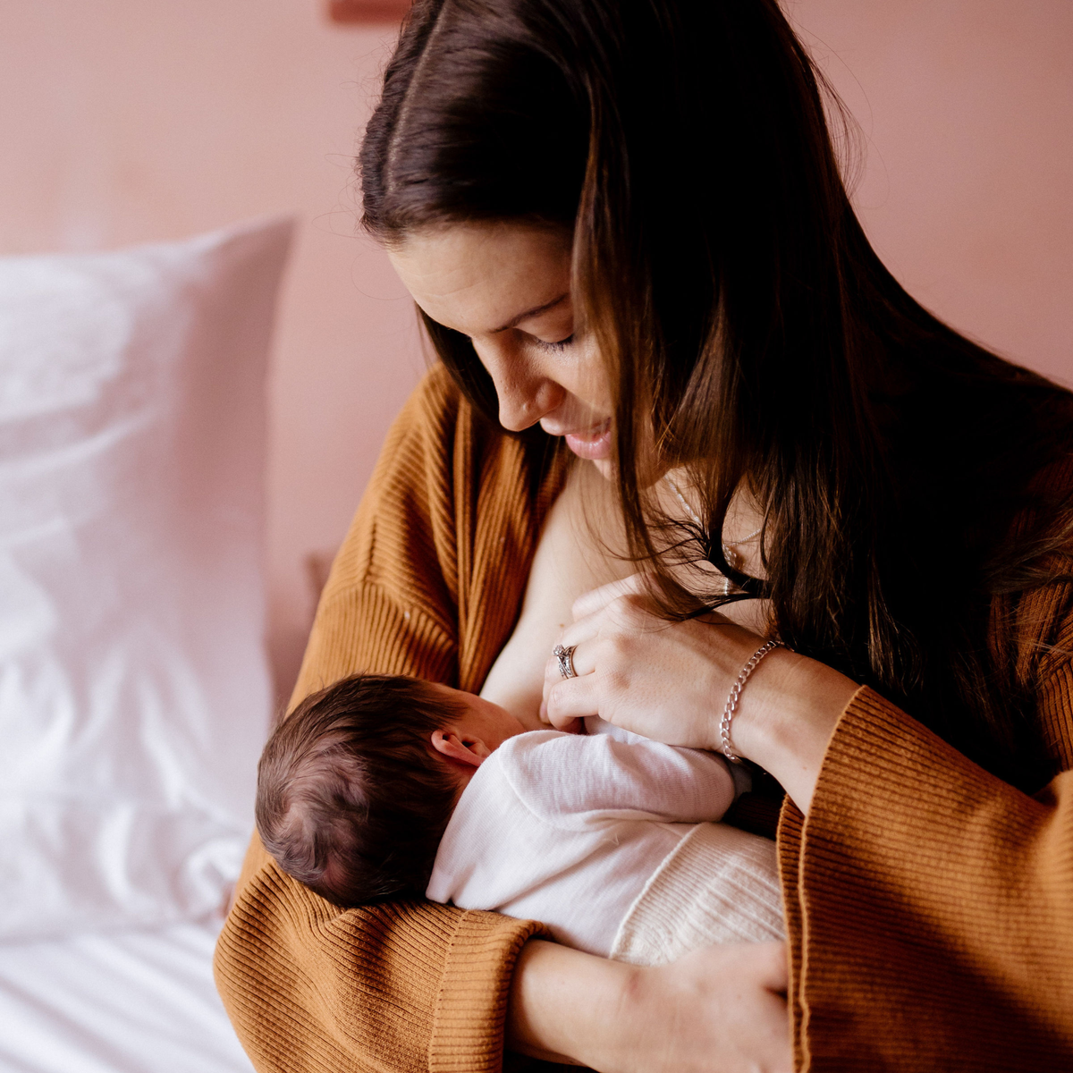 woman breastfeeding newborn baby
