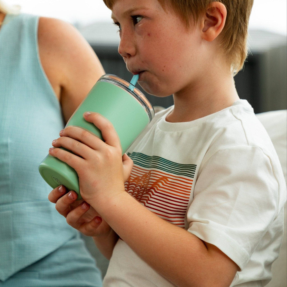 Child drinking from the Starting Solids Australia Mini Straw Tumbler in Mint Crisp