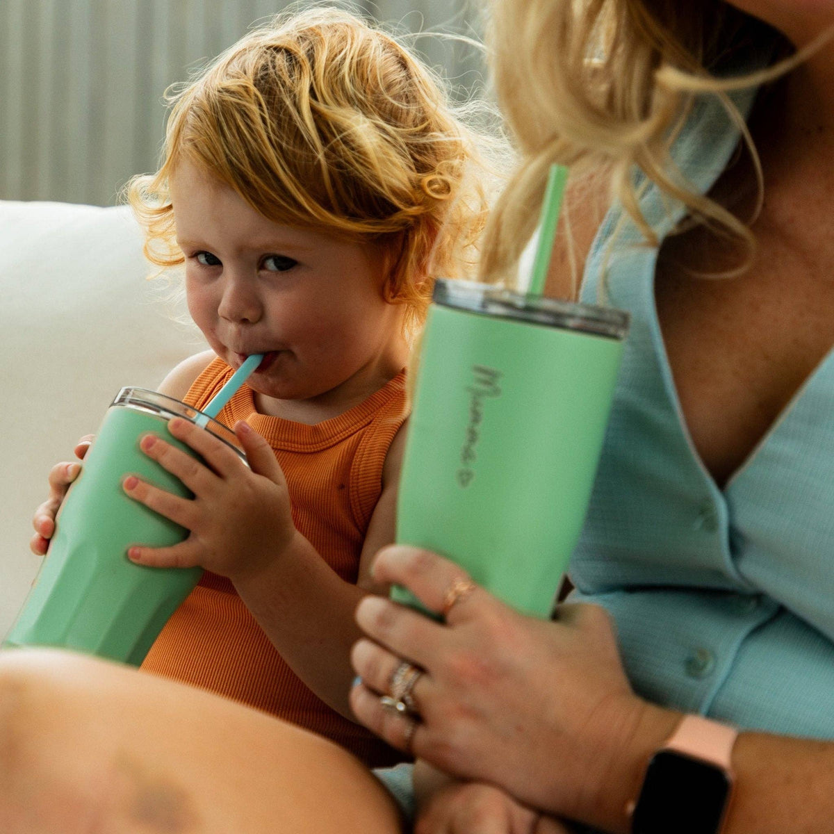 Toddler sipping from a Mini Straw Tumbler beside mum's matching tumbler