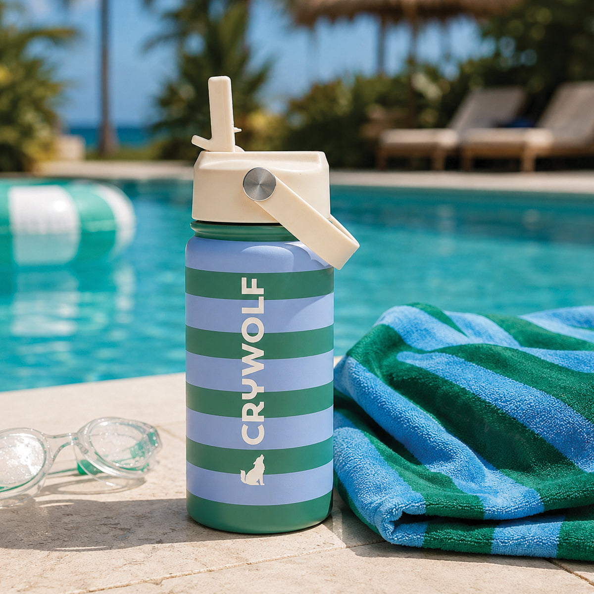 Crywolf 400ml drink bottle in Deck Stripe poolside with a beach towel