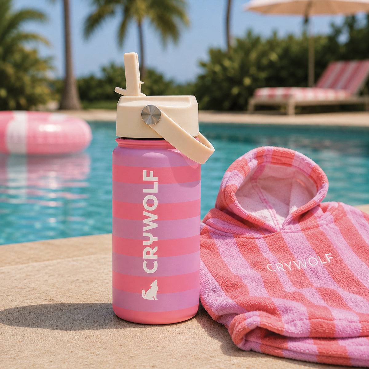 Crywolf 400ml drink bottle in Flamingo Stripe poolside with a hooded towel