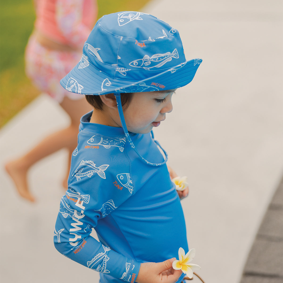 Child wearing the Crywolf Long Sleeve Rash Vest in Saltwater