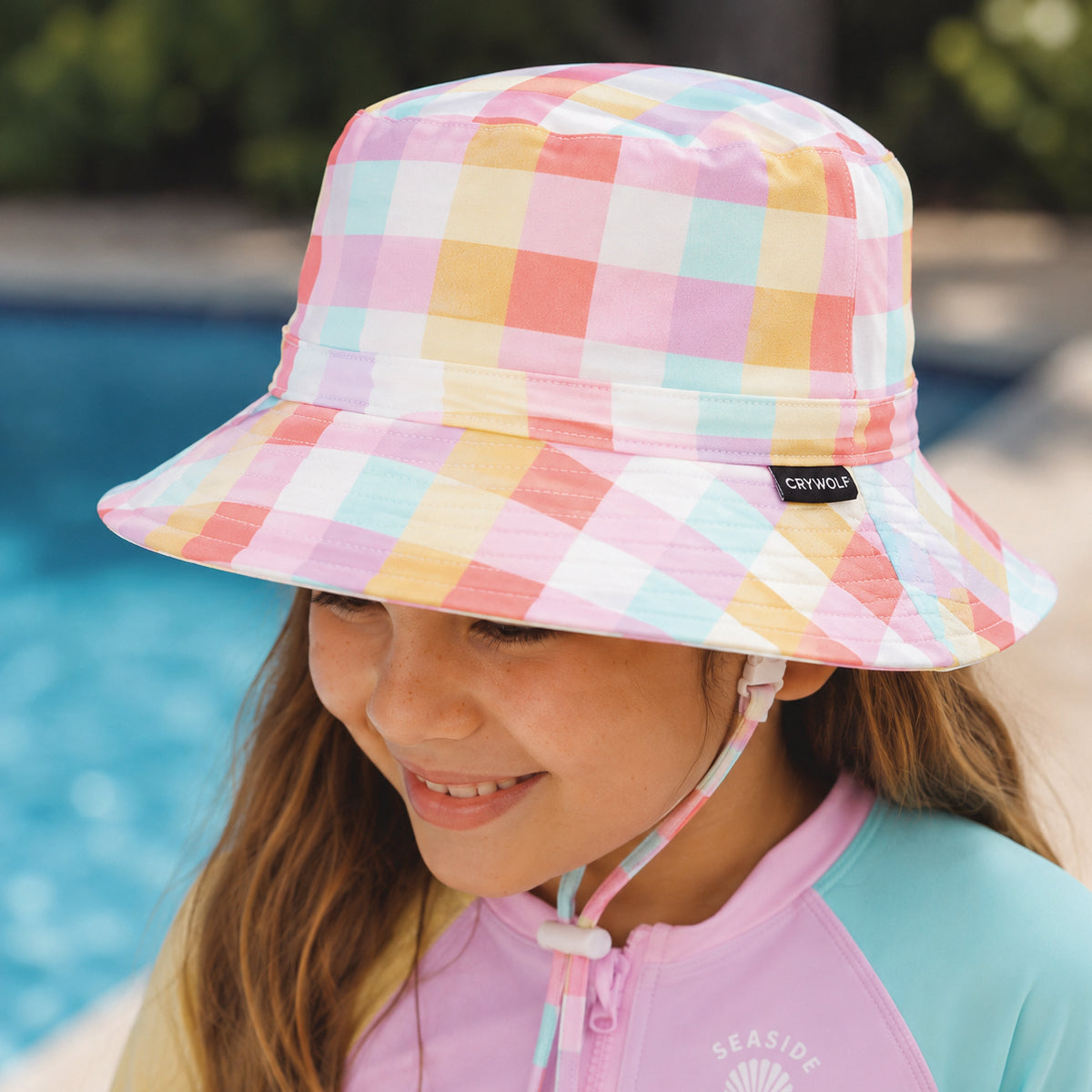 Child wearing the Crywolf Swim Bucket Hat in Pop Gingham