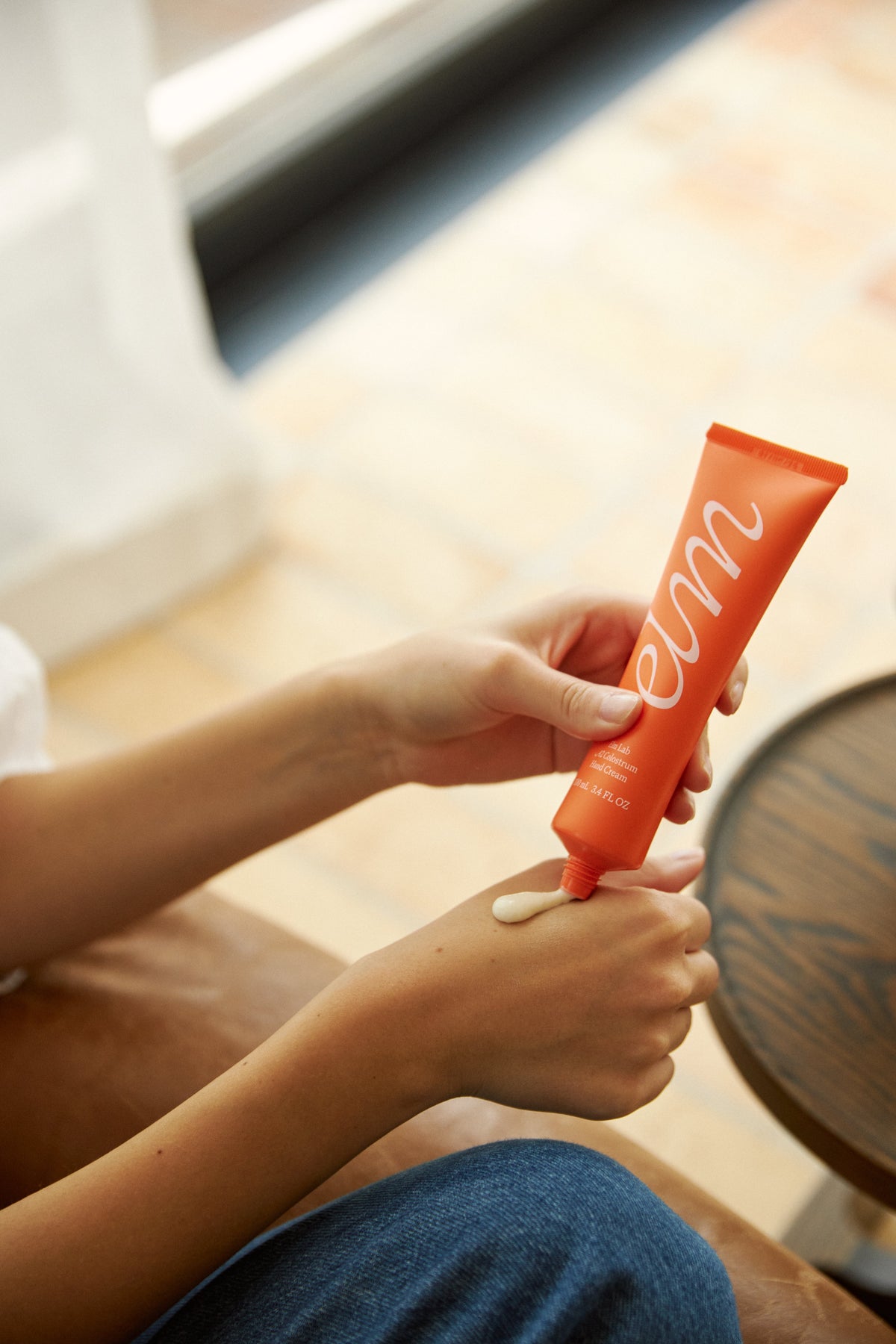 Applying Elm Lab Colostrum Hand Cream