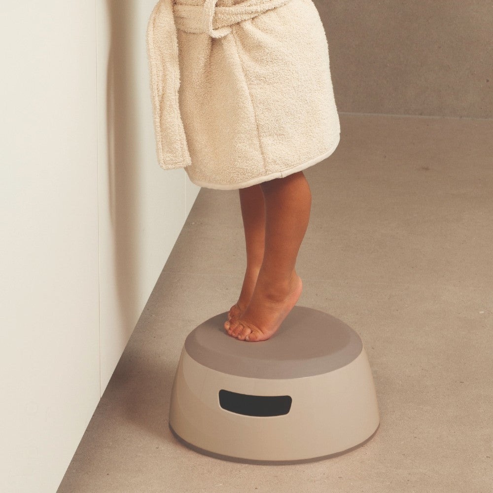 Luma Step Stool in Almond, in use at the basin