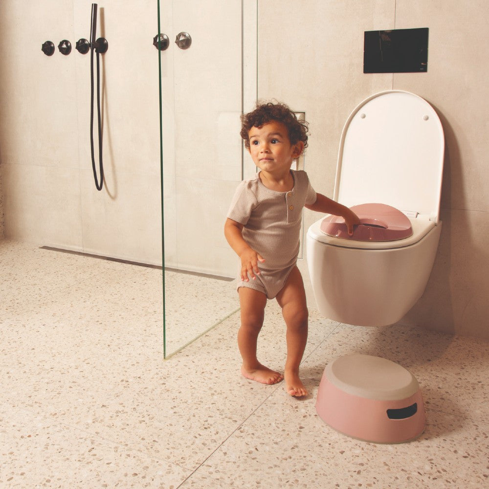 Luma Toilet Training Seat in Blush Pink, fitted to a toilet