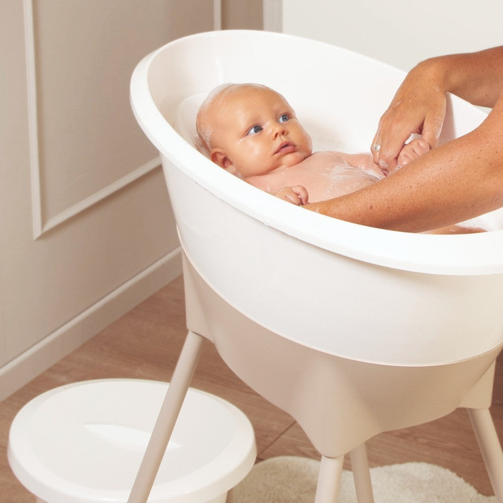 Luma Baby Bath Stand in Almond, folded legs