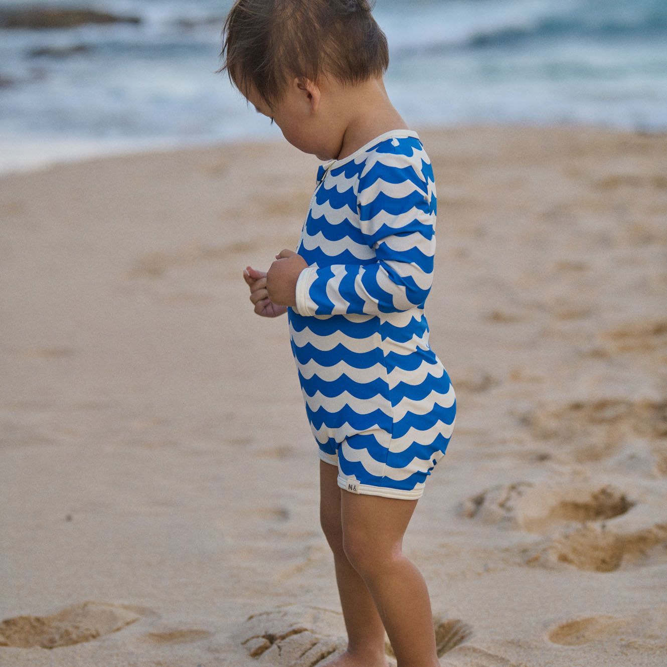 One Piece Bathing Trunks in Waves Blue Print worn by child