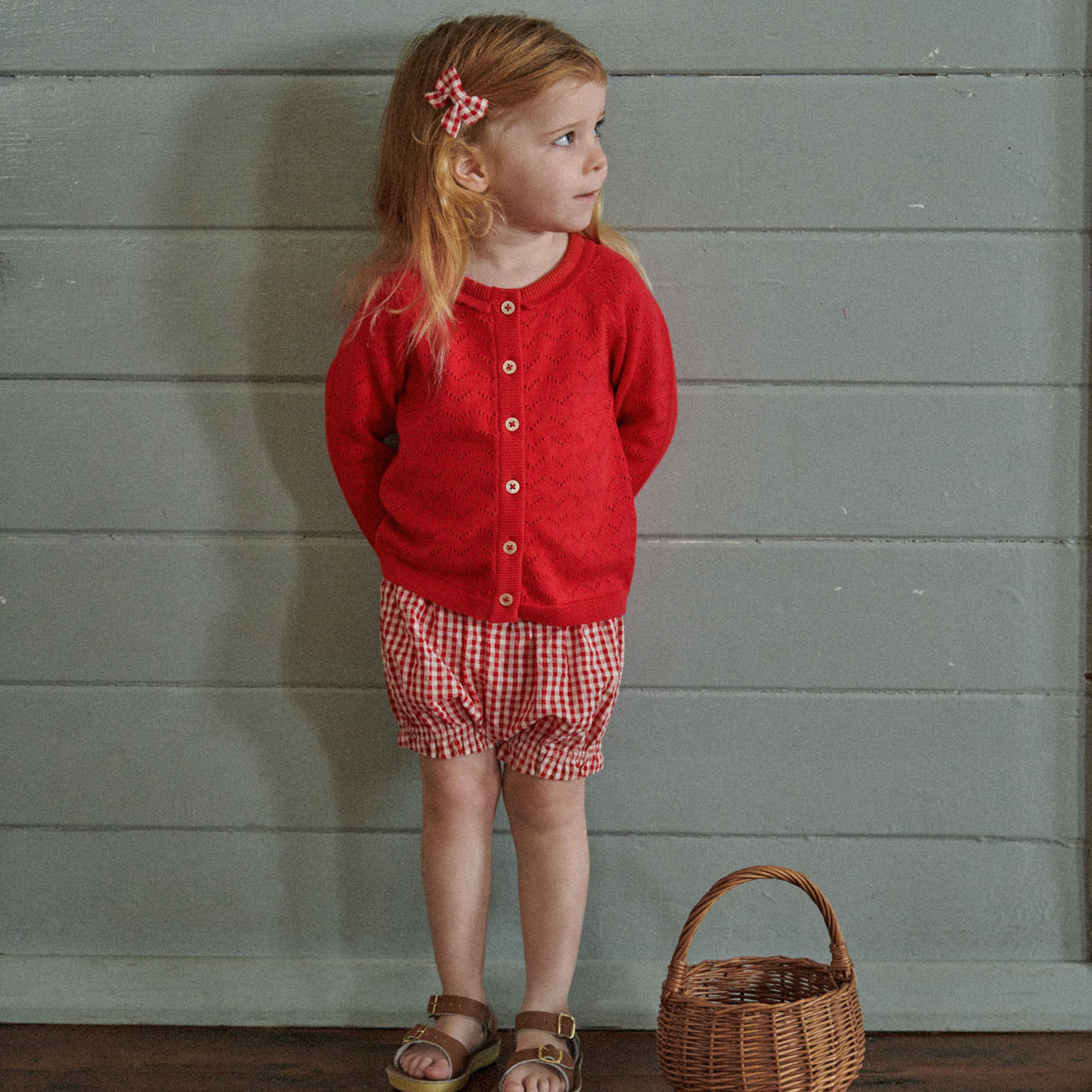 Piper Cardigan in Raspberry Red Pointelle worn by child