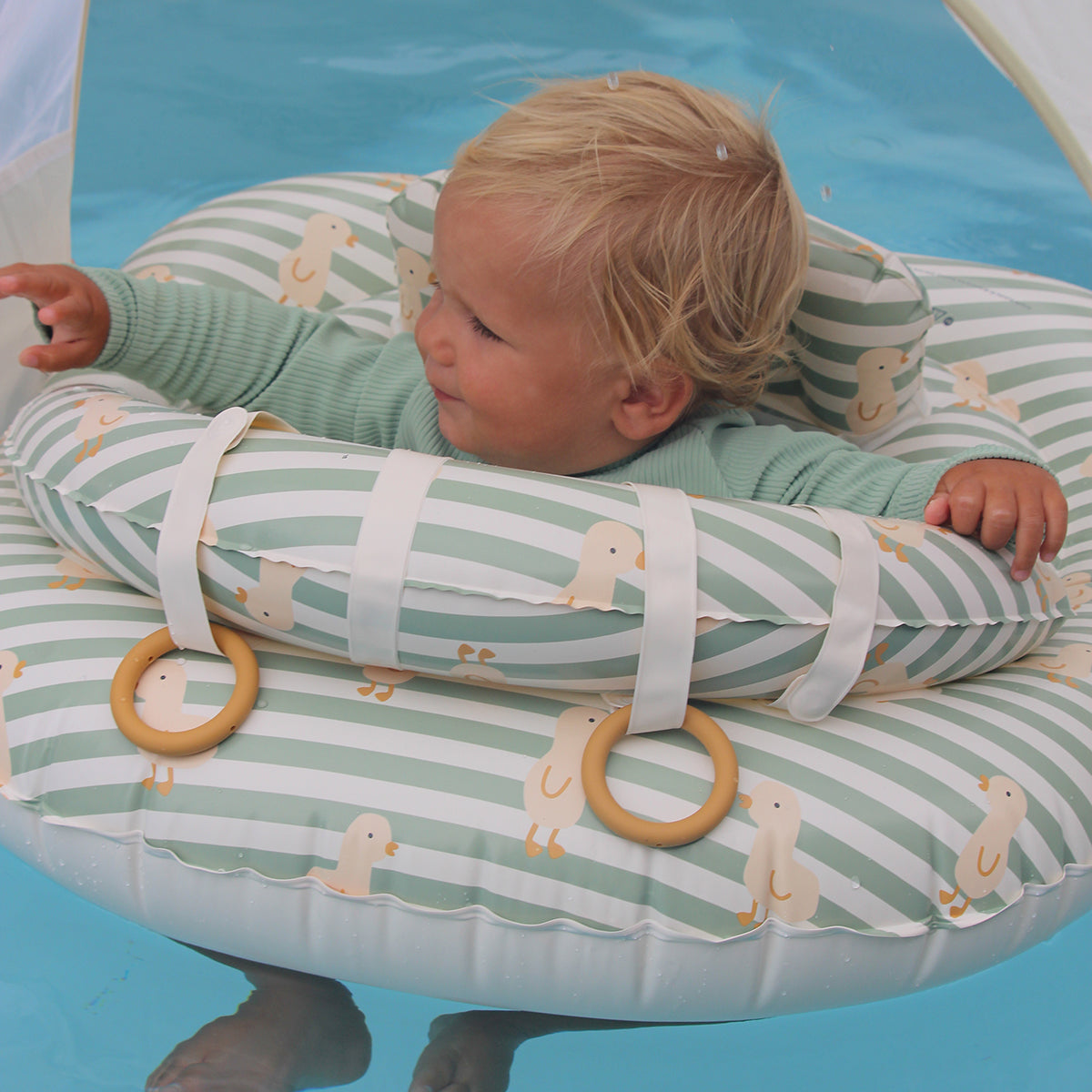 Baby playing with the silicone rings on the Sunnylife Interactive Baby Float