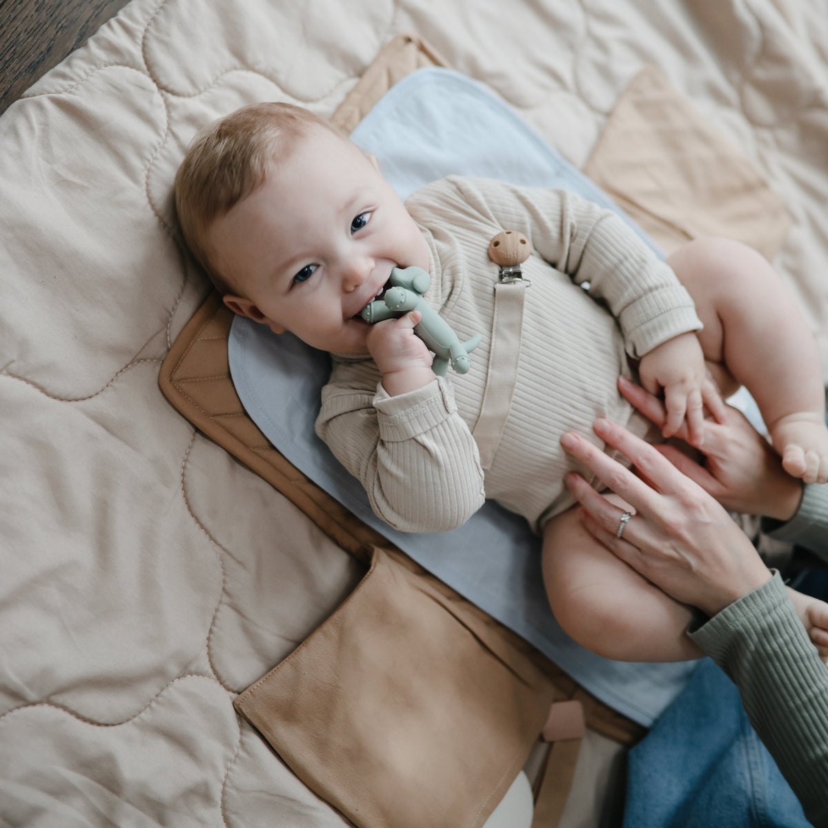 Baby chewing the Mushie Dog Figurine Teether