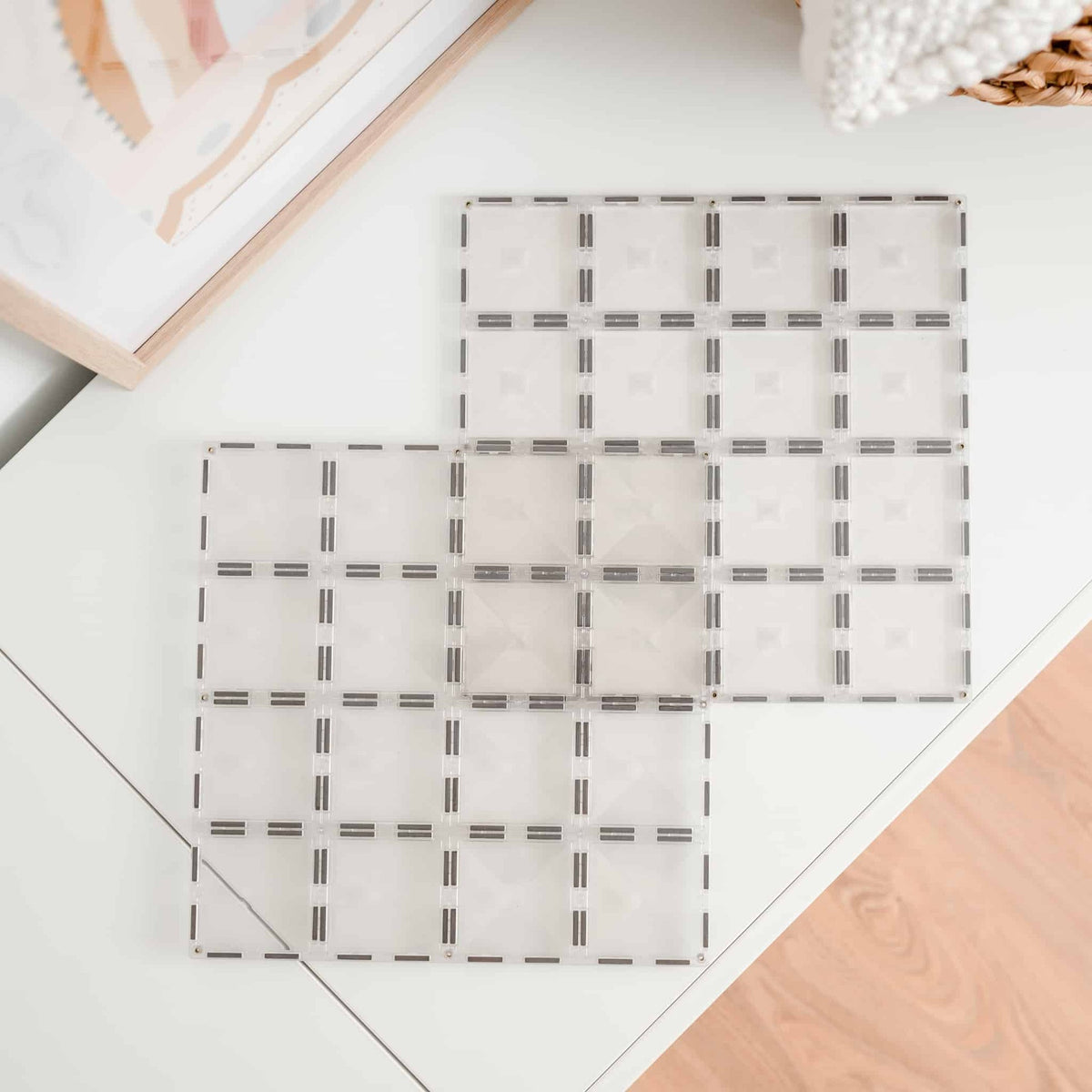 Clear Connetix base plates laid on the floor