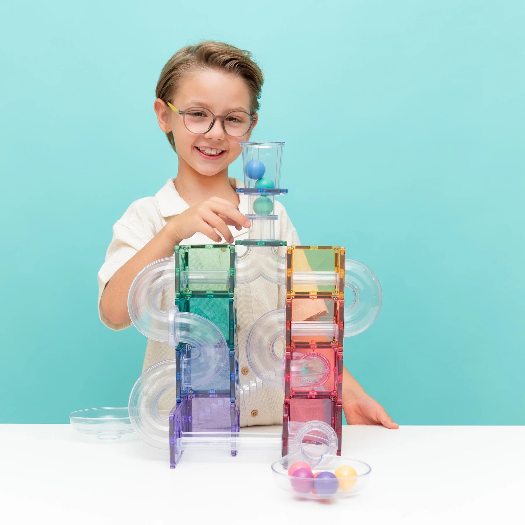 Connetix pastel ball run build with spiral tubes and wooden balls