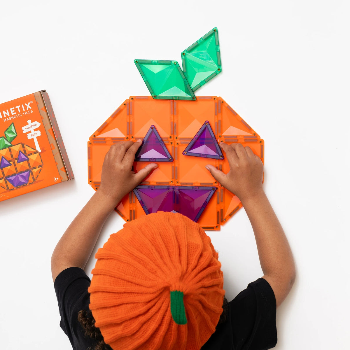 Child building the Connetix Halloween Pumpkin magnetic tile pack