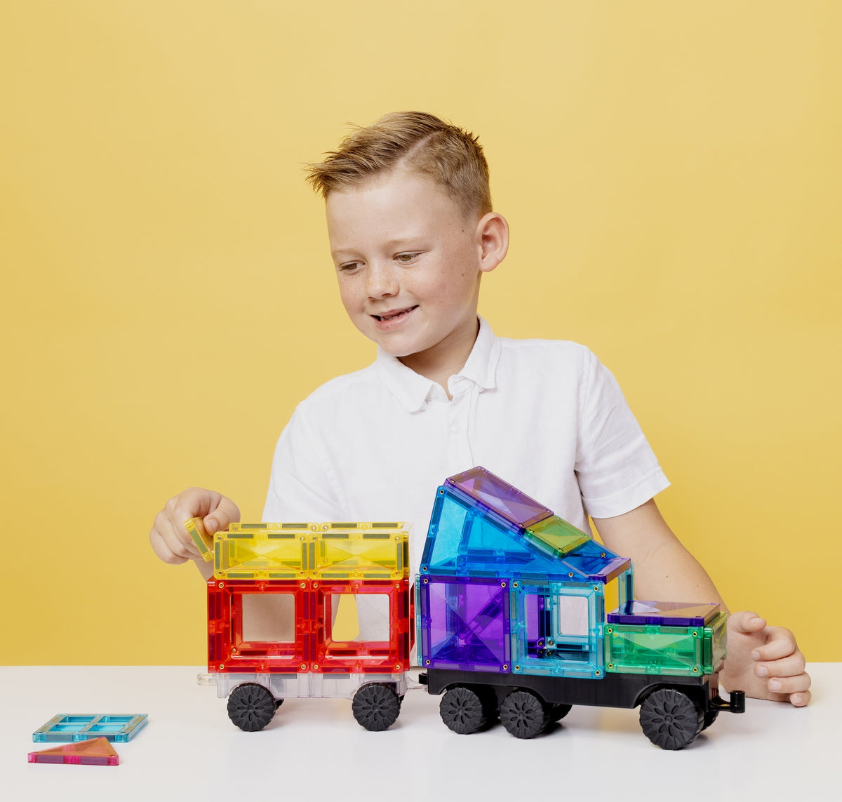 Child building vehicles with Connetix Bright Transport Pack