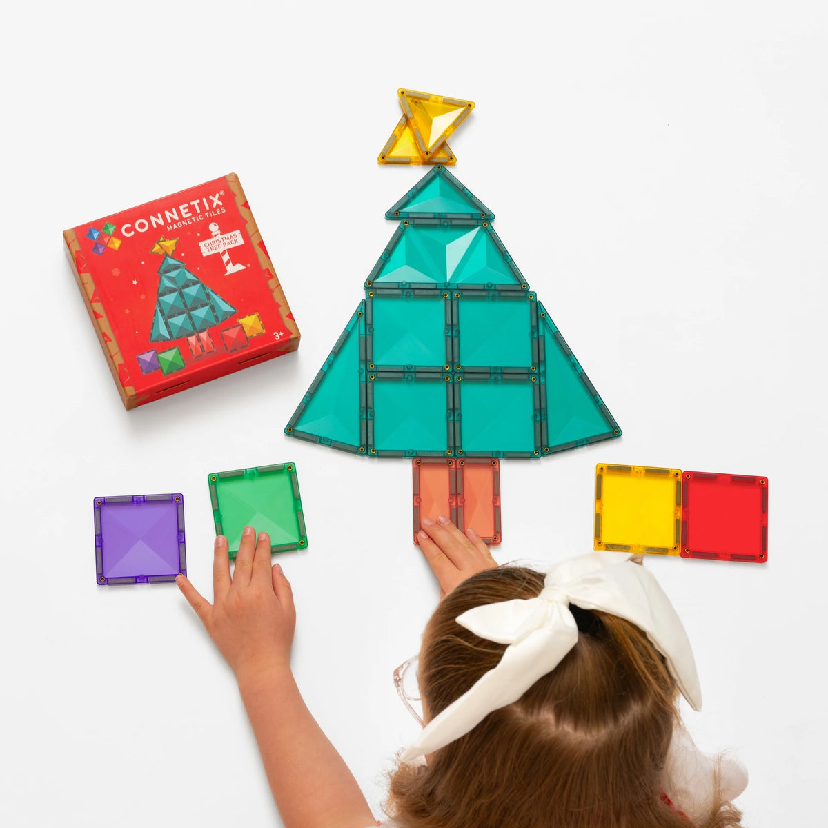 Child building the Connetix Christmas Tree magnetic tile pack
