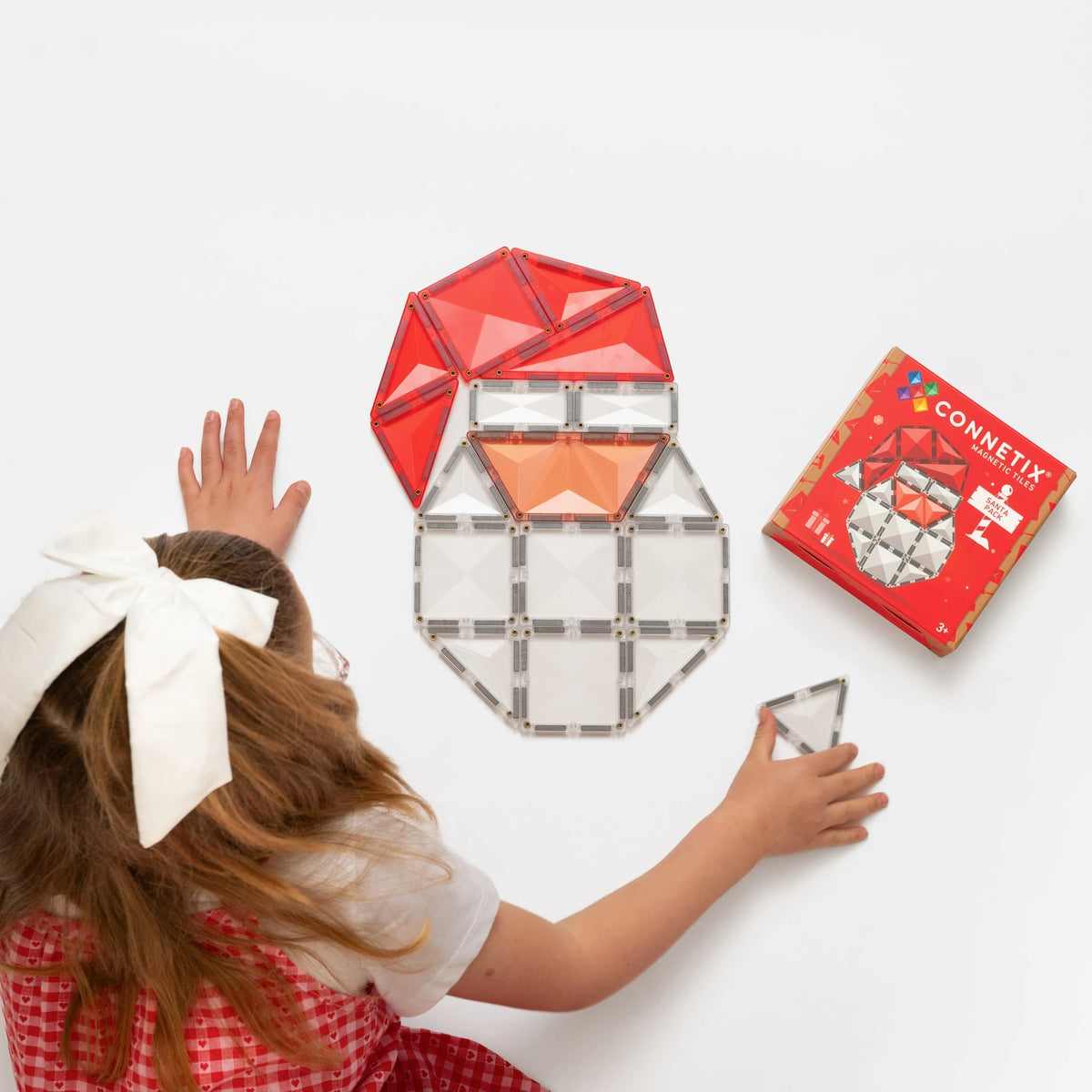 Child building the Connetix Christmas Santa magnetic tile pack