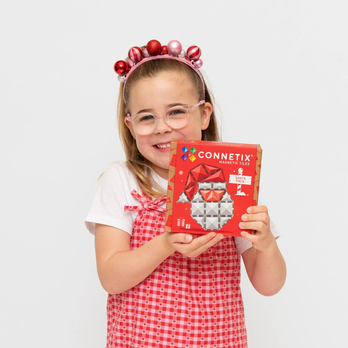 Child holding the Connetix Christmas Santa Pack box