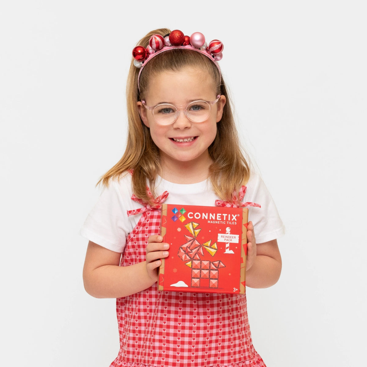 Child holding the Connetix Christmas Reindeer Pack box