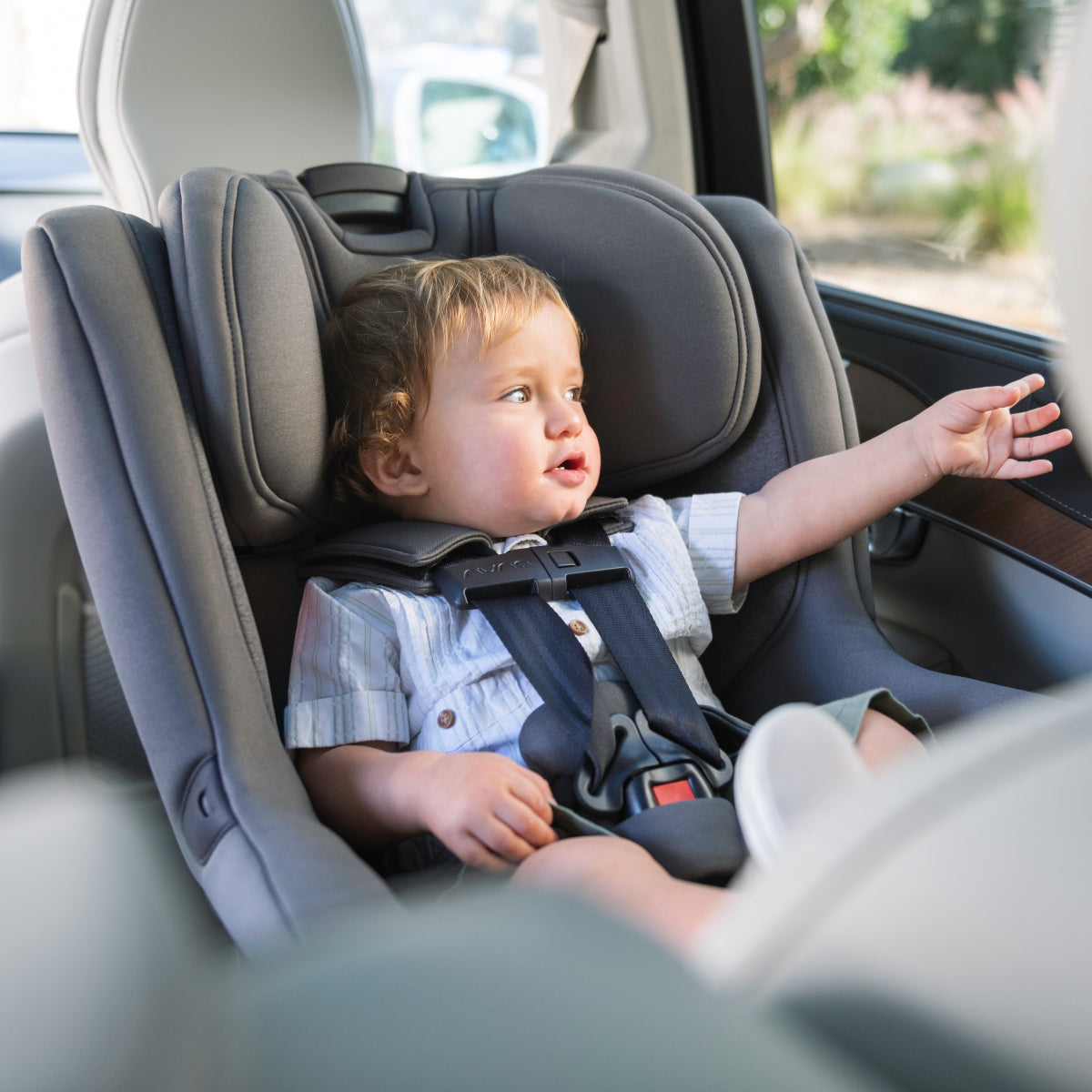 Nuna RAVA car seat lifestyle shot with toddler