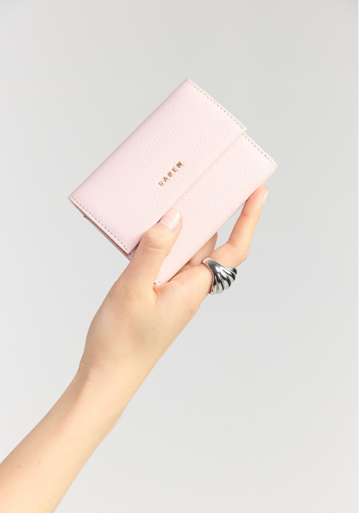 saben pico tri-fold wallet ambrosia held in hand