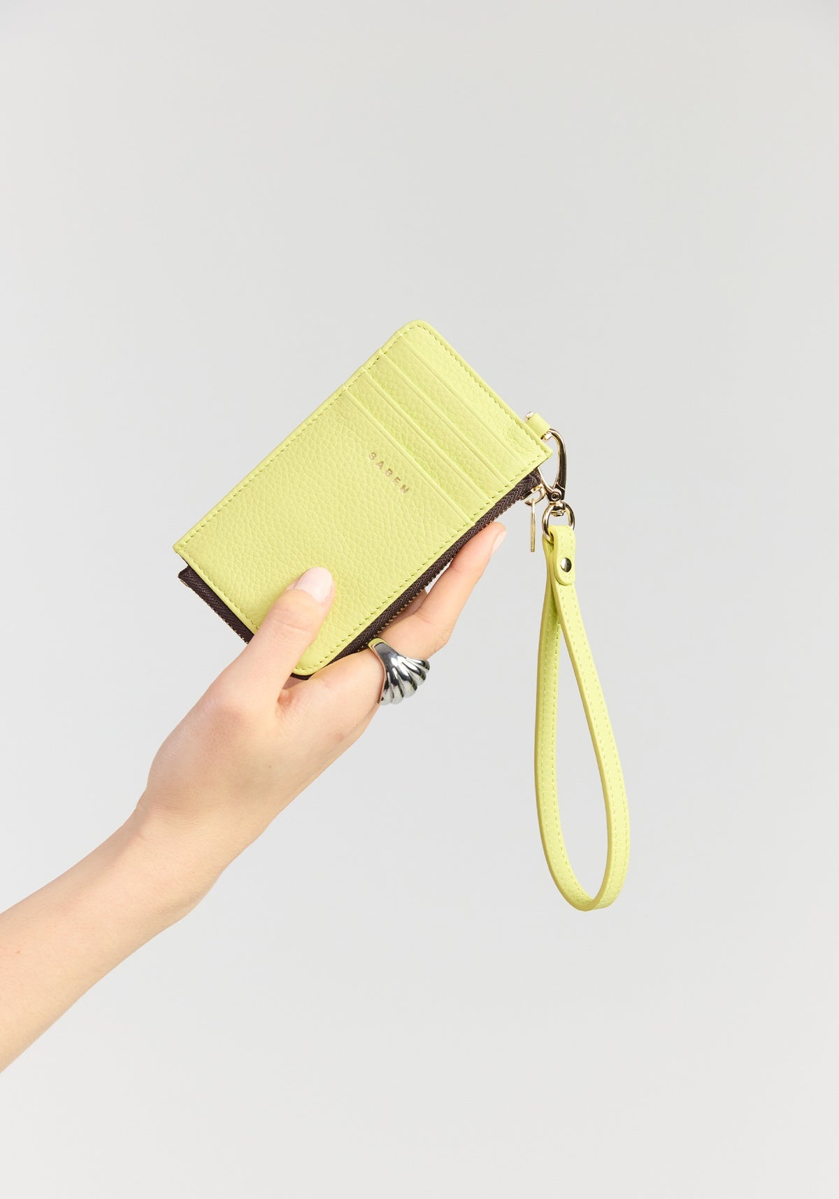 saben winona card holder wristlet pistachio held in hand