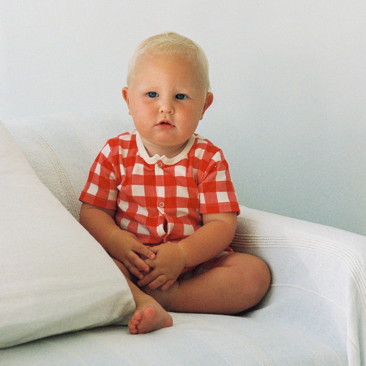 Summer Sleepy Suit in Red Crispin Check worn by baby