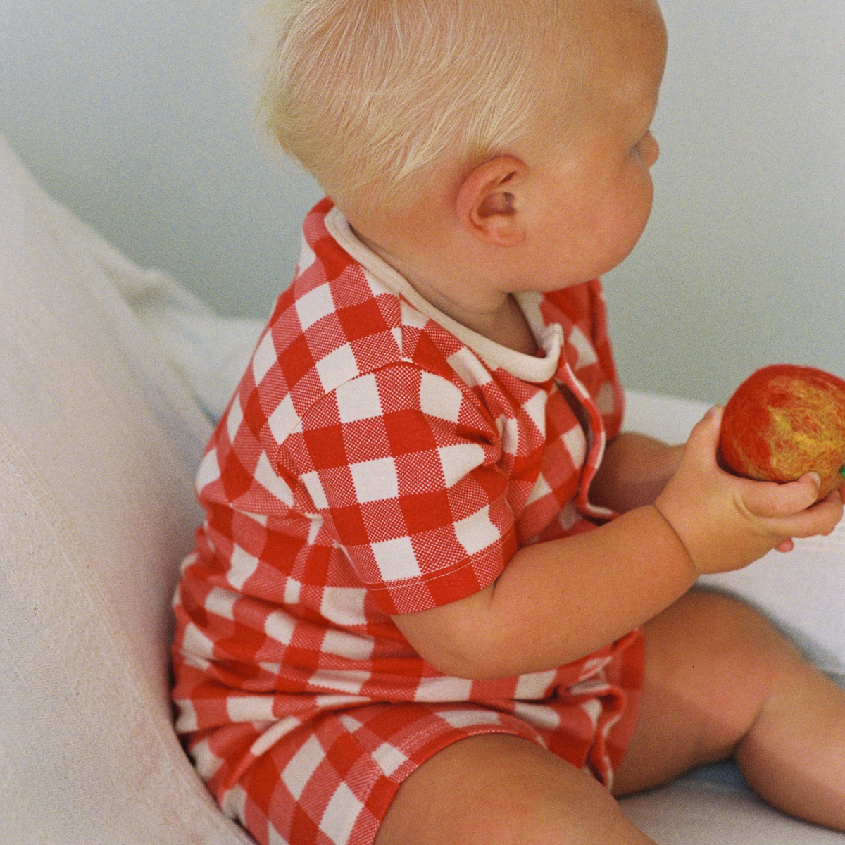 Summer Sleepy Suit in Red Crispin Check worn by baby