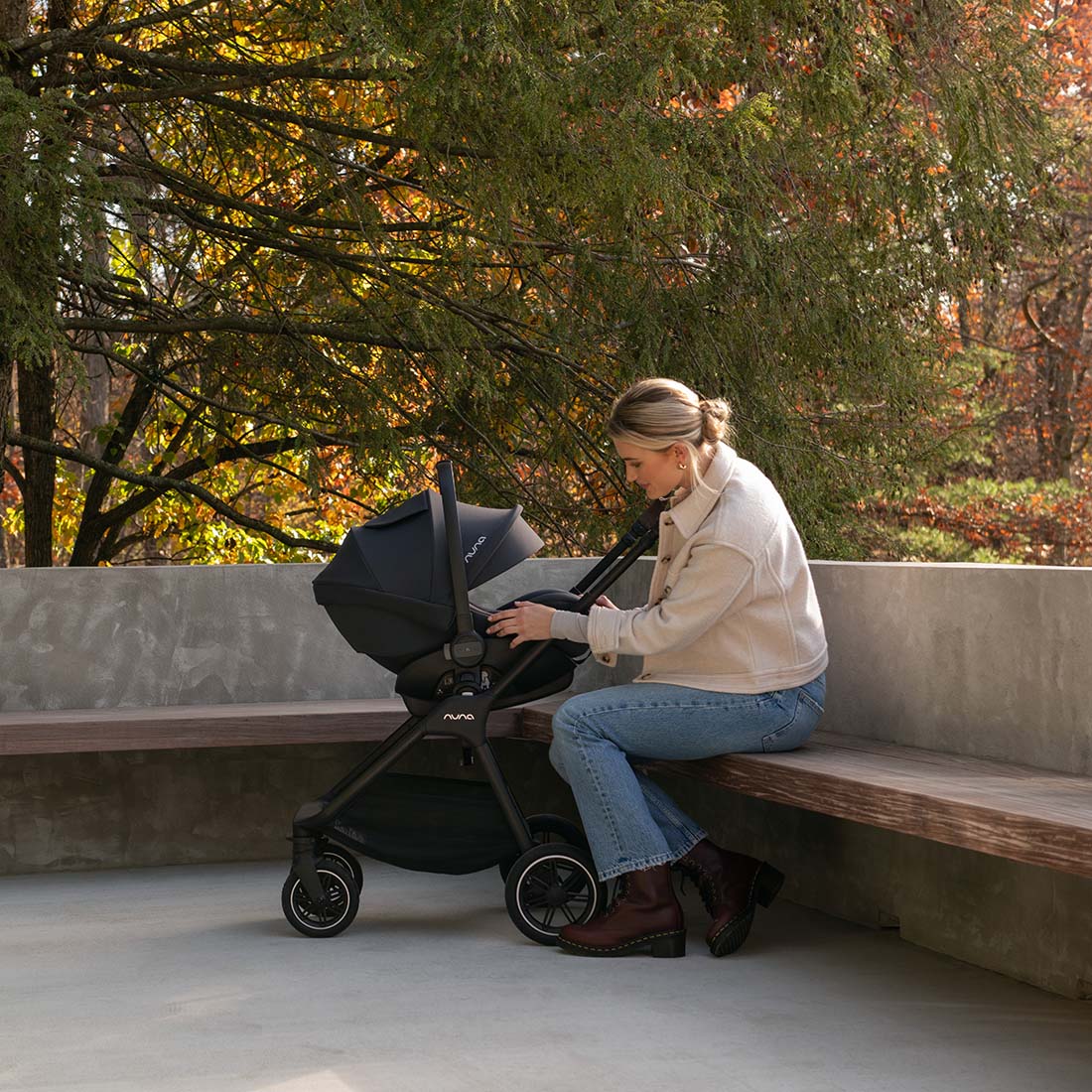 Parent with the Nuna TRIV Next in Caviar as a travel system